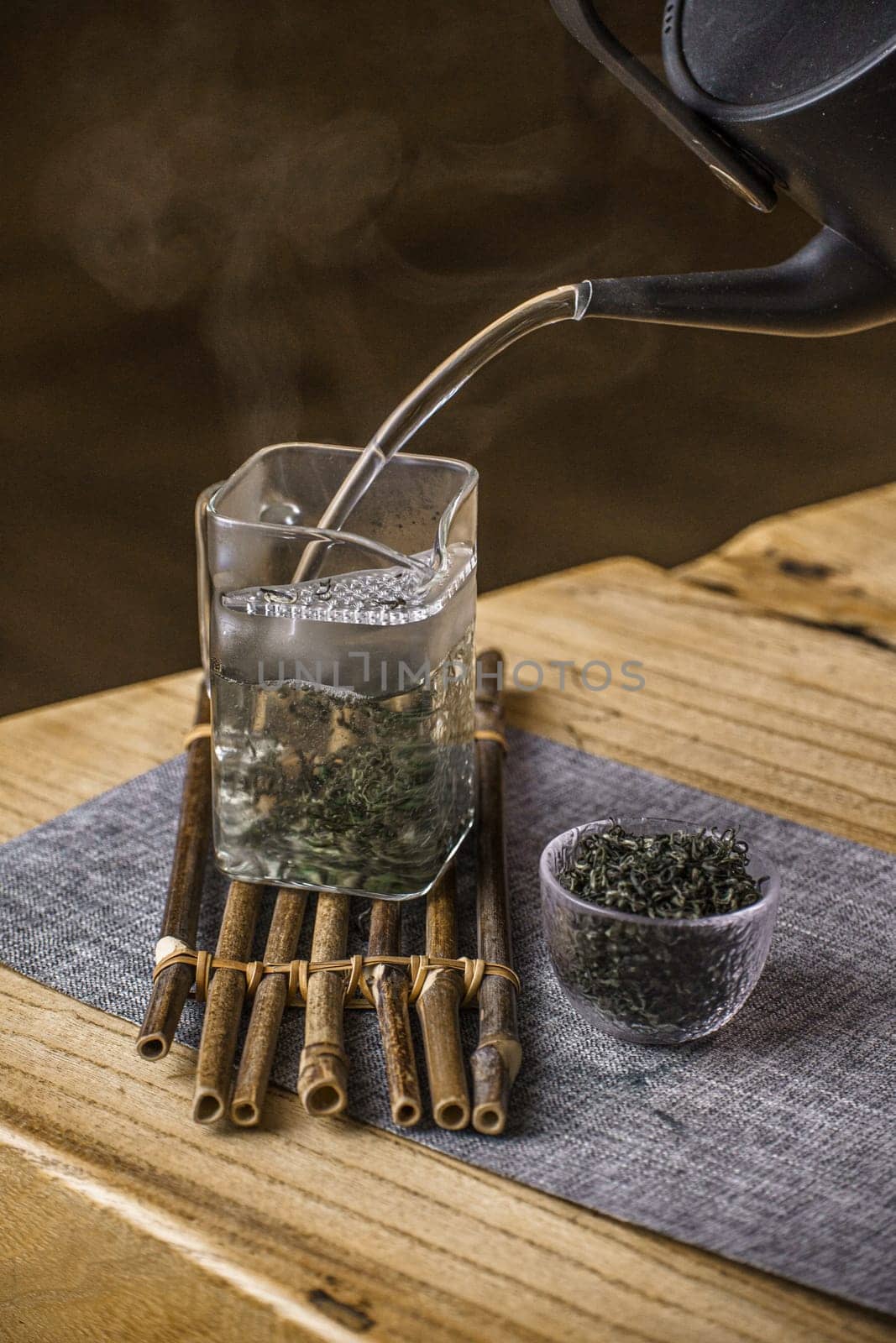 Expert tea preparation with elegant bamboo elements, showcasing the tranquil essence of tea culture