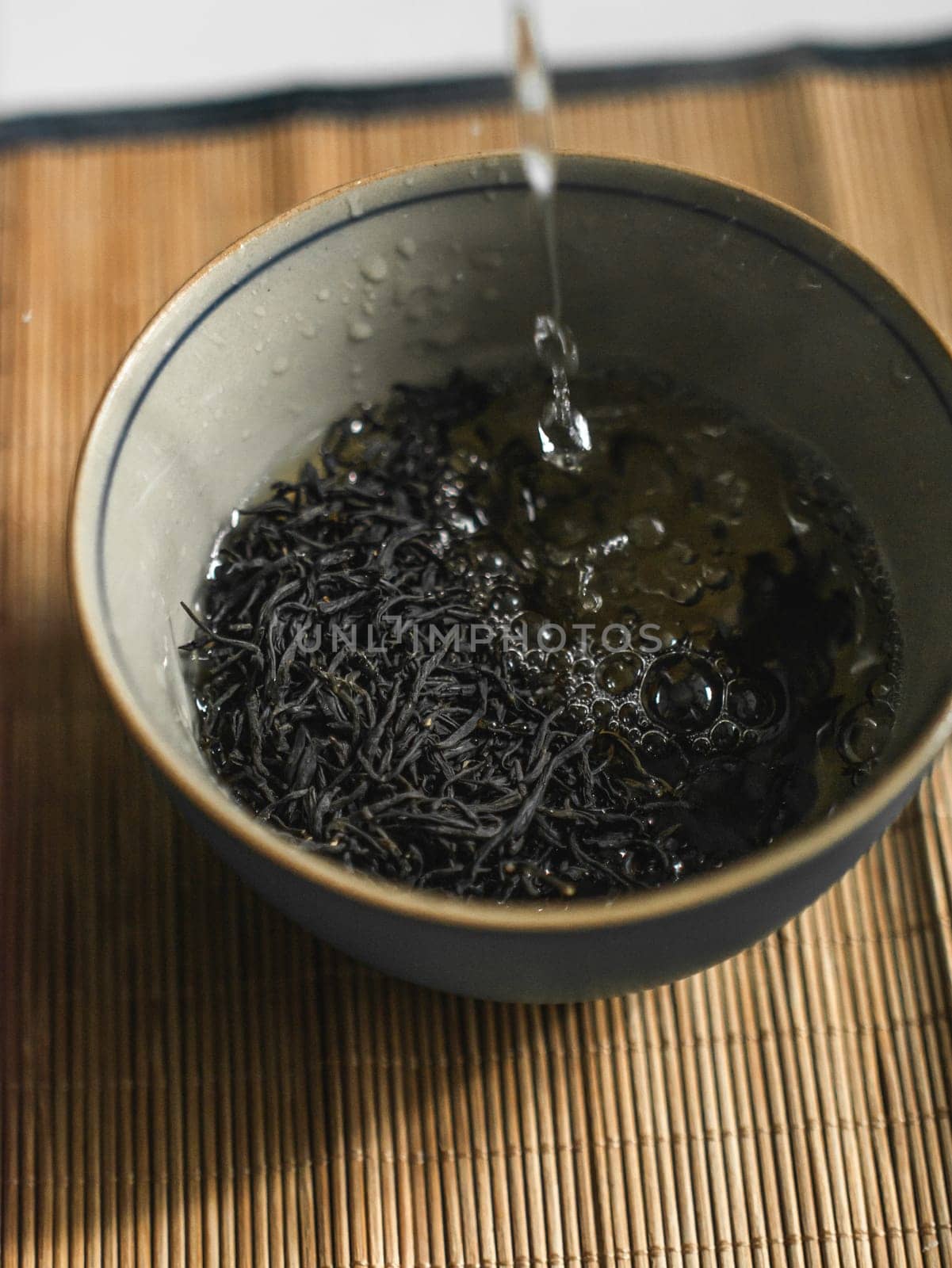 A truly serene moment of brewing loose leaf tea in a beautifully crafted bowl filled with steaming water