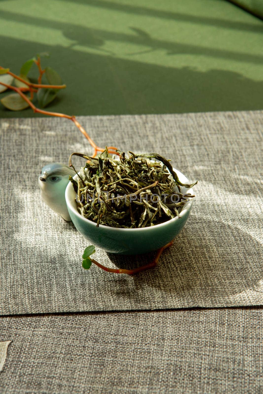 A tranquil tea setting adorned with fresh leaves, perfect for promoting relaxation and mindfulness activities