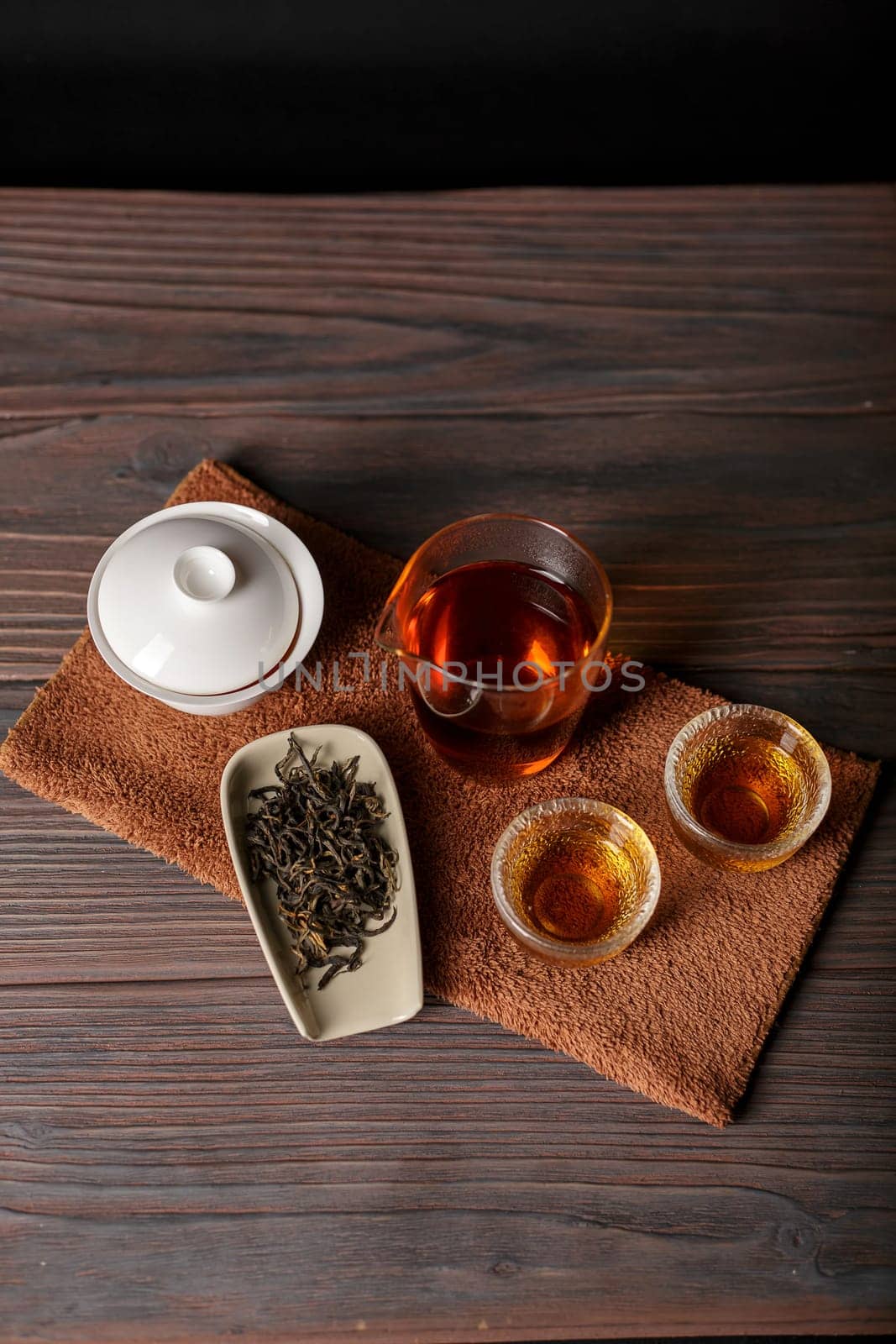 Immerse yourself in the exquisite art of tea with loose leaves, elegant cups, and a traditional pot for brewing