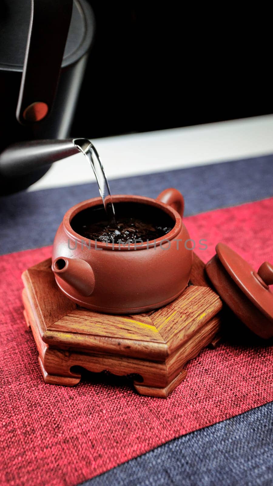 A Yixing teapot elegantly pours tea, showcasing the art of brewing in a cozy atmosphere for enjoyment and relaxation