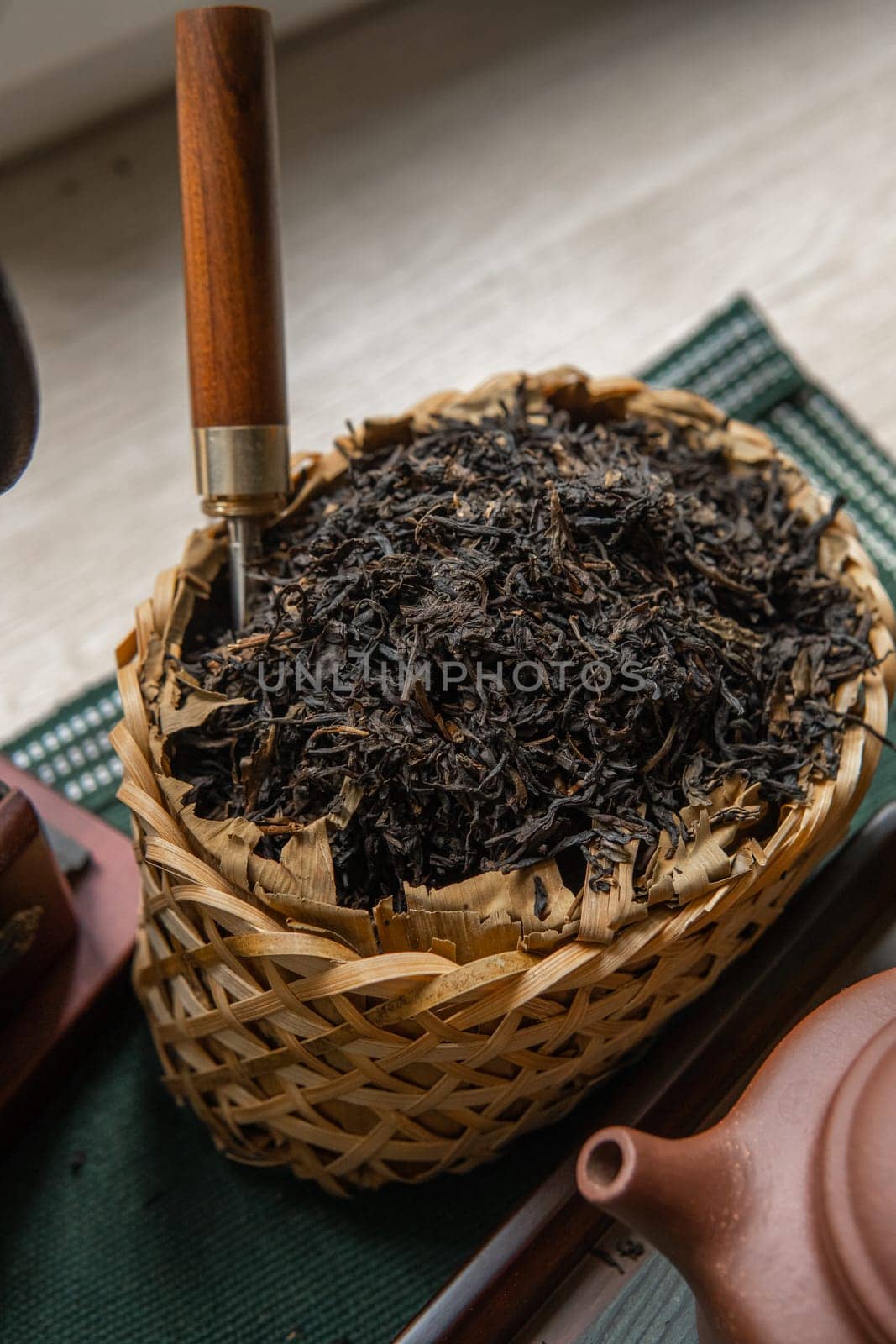 Aesthetic photo of beautifully crafted loose leaf black tea, elegantly displayed in a traditional basket