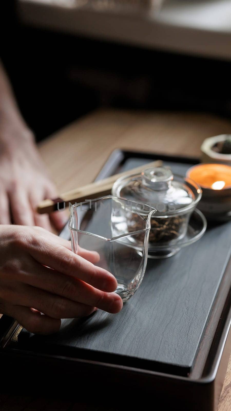 Enjoy a serene tea brewing moment with beautiful glassware and nature, perfect for relaxation and tranquility