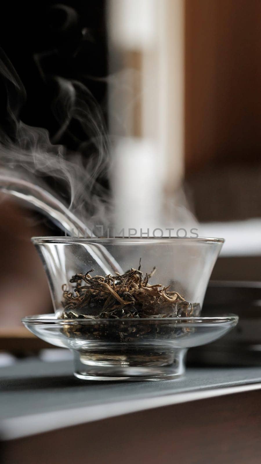 This image shows a closeup of steaming herbal tea in a glass teapot, highlighting its natural beauty and warmth
