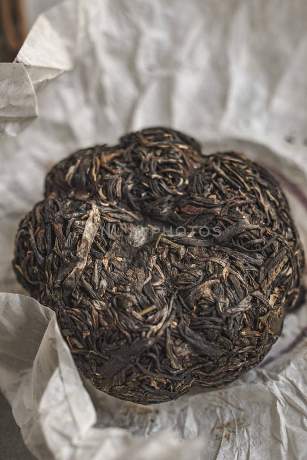A closeup view of a beautifully compressed Puerh tea, showcasing its intricate leaf structure and unique texture