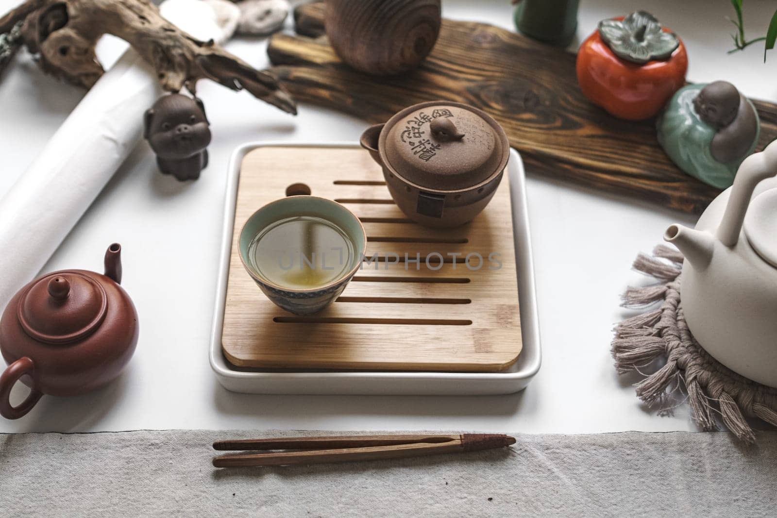 A serene tea setup with traditional teapots, elegant cups, and calming elements for relaxation and peace