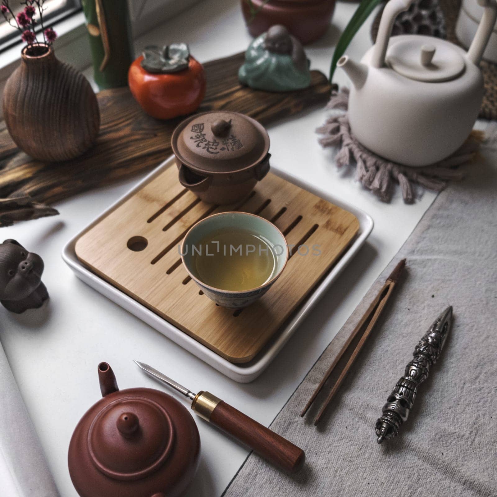 A beautifully serene setup of elegant tea utensils that exquisitely showcases both elegance and tranquility