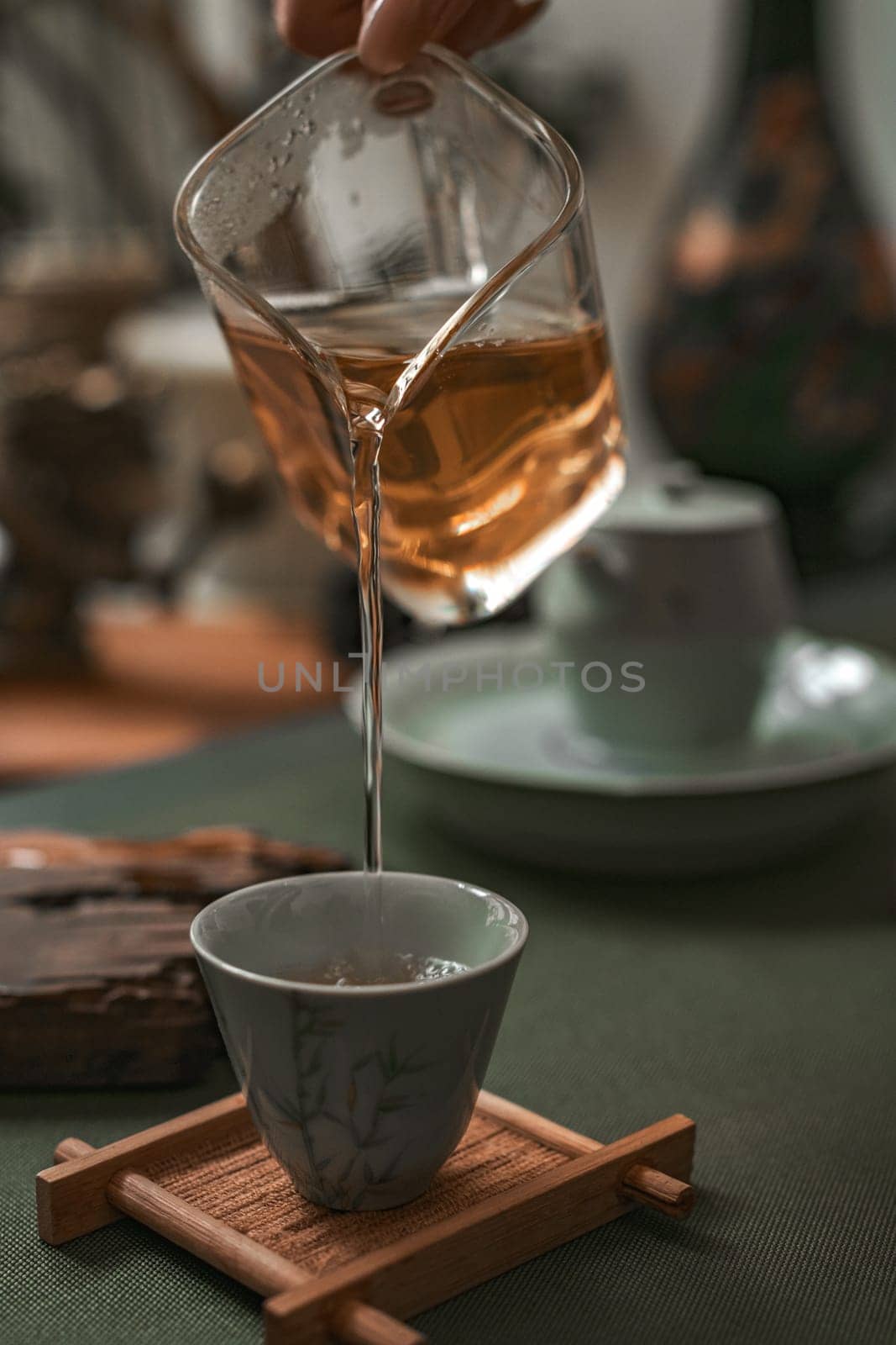 Capturing the timeless elegance of tea brewing through a graceful and gentle pour into a delicate fine cup