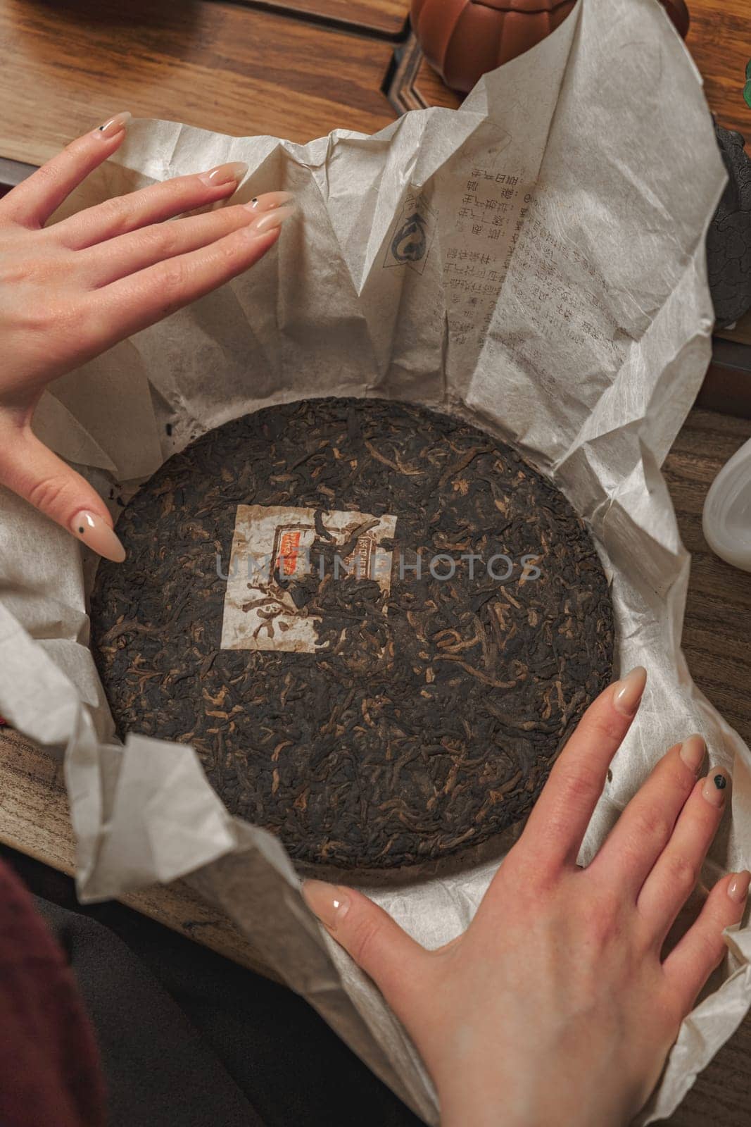 An exquisite tea cake surrounded by natural, organic wrapping, perfectly ready for tea enthusiasts to enjoy
