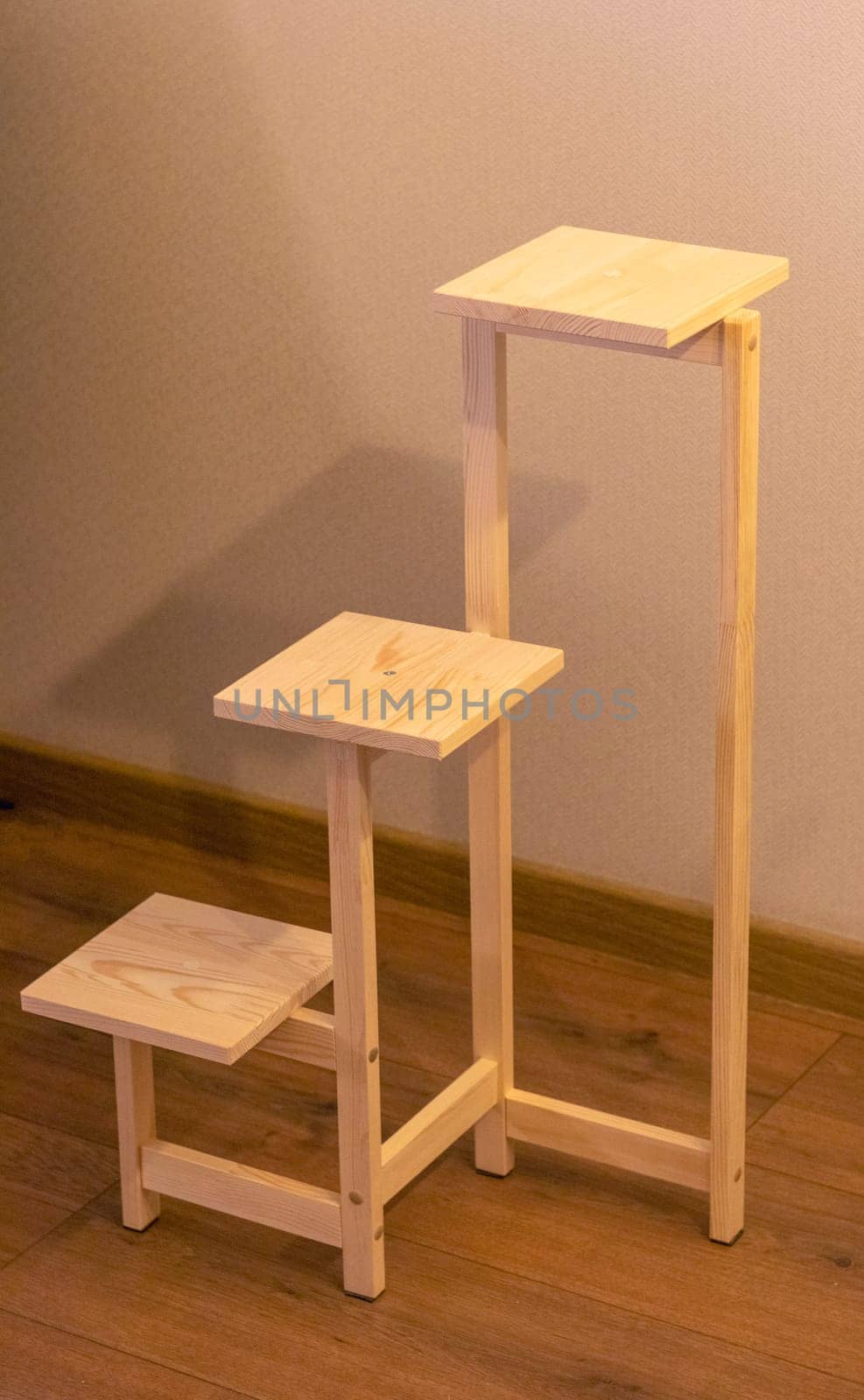 Close up shot of assembled wooden shelf for plants in pots