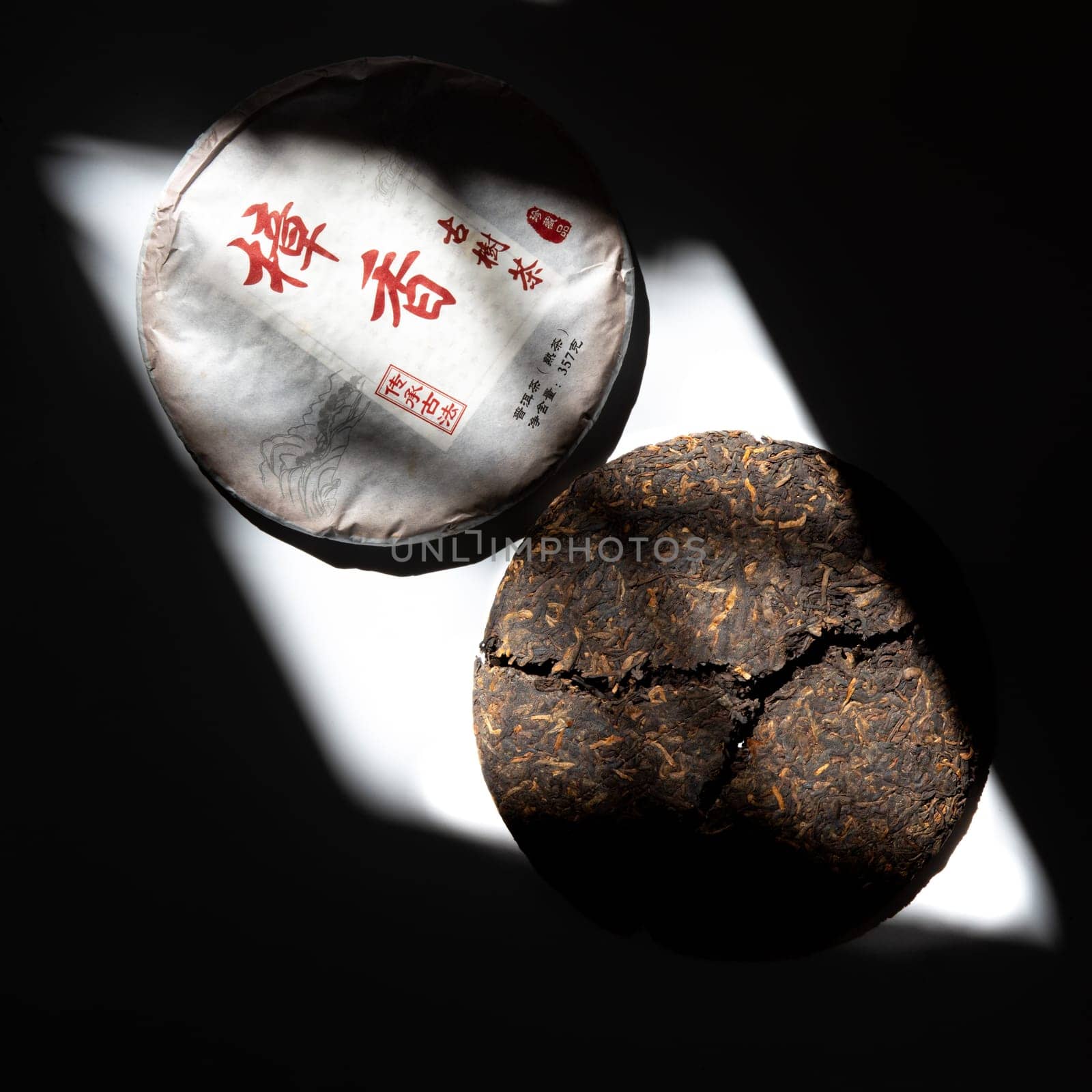 This authentic Puerh tea cake beautifully showcases its unique texture along with its traditional packaging design