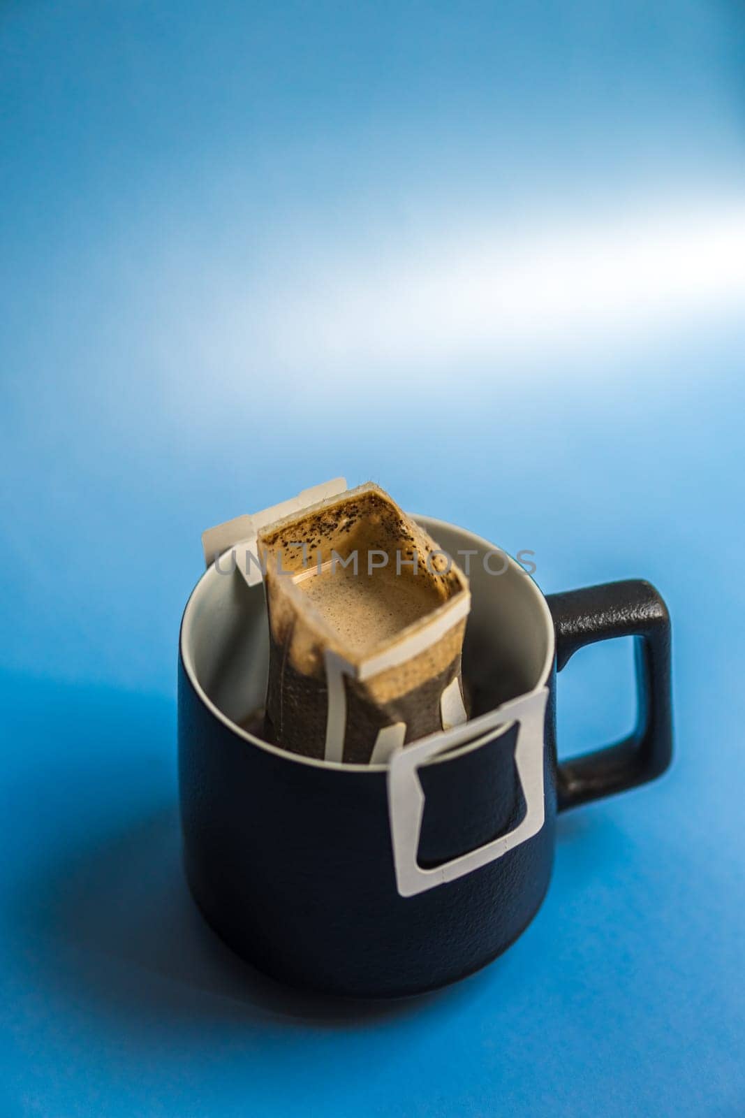 An elegant black mug with a creative tea infuser, perfect for tea lovers and unique kitchenware fans