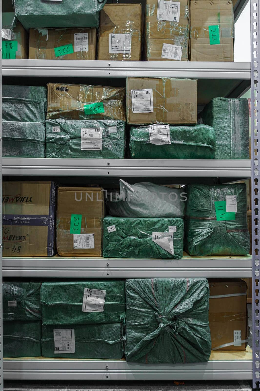 Shelves meticulously organized and filled with wrapped media stock packages that are ready for distribution purposes