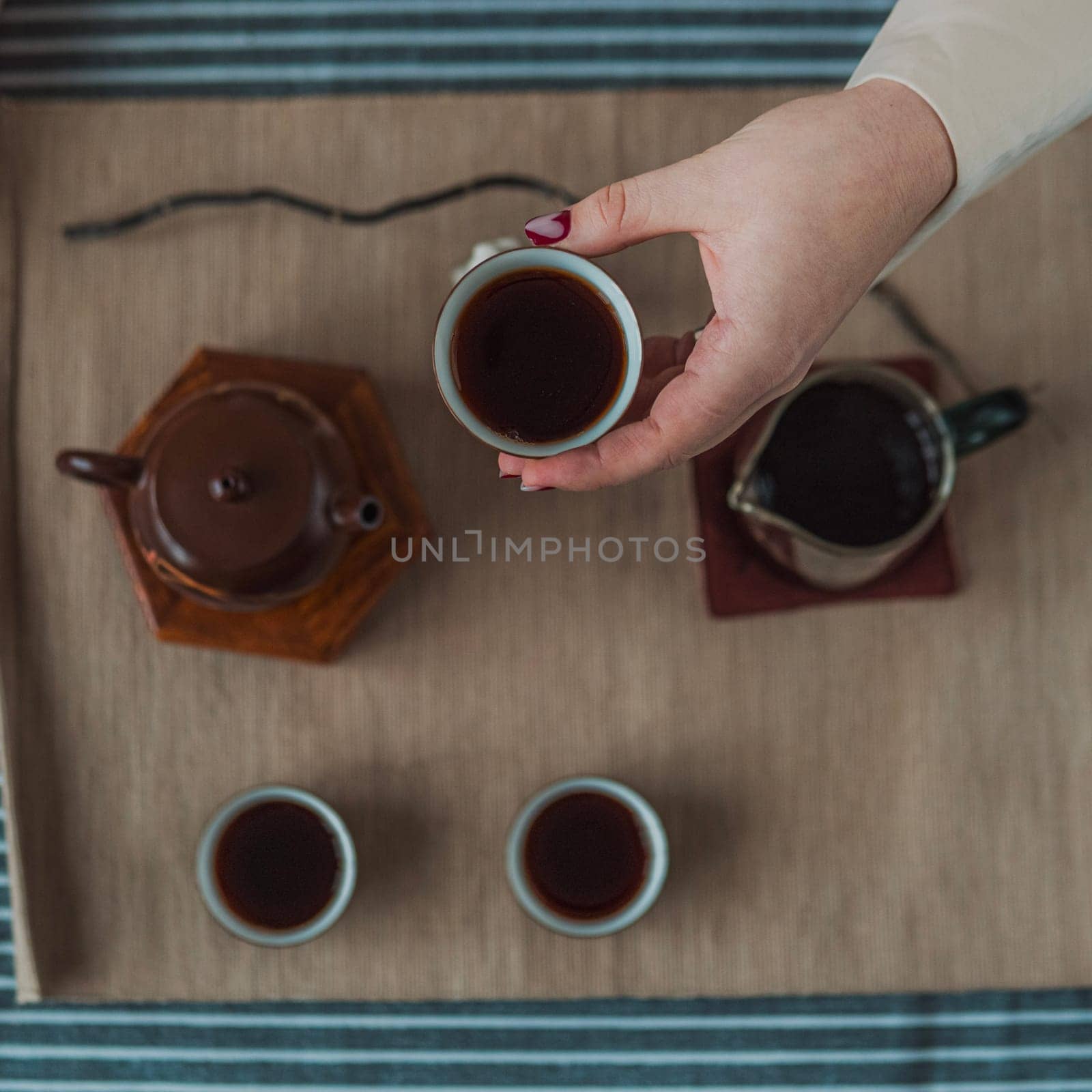 Immerse yourself in the exquisite art of tea with a calming setup that highlights a beautiful teapot and cups
