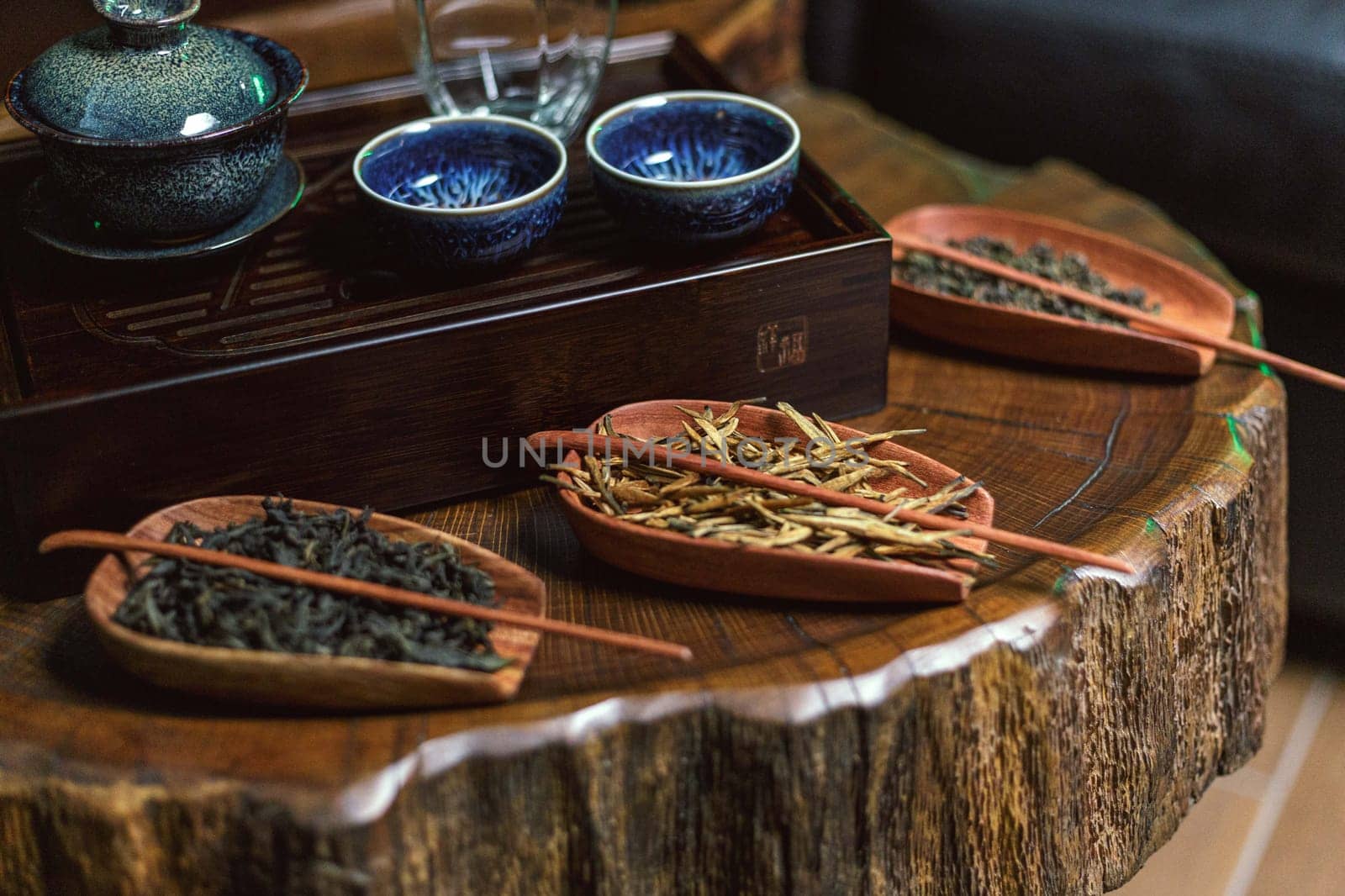 A beautifully serene tea arrangement showcasing a variety of diverse teas on a charming rustic wooden surface