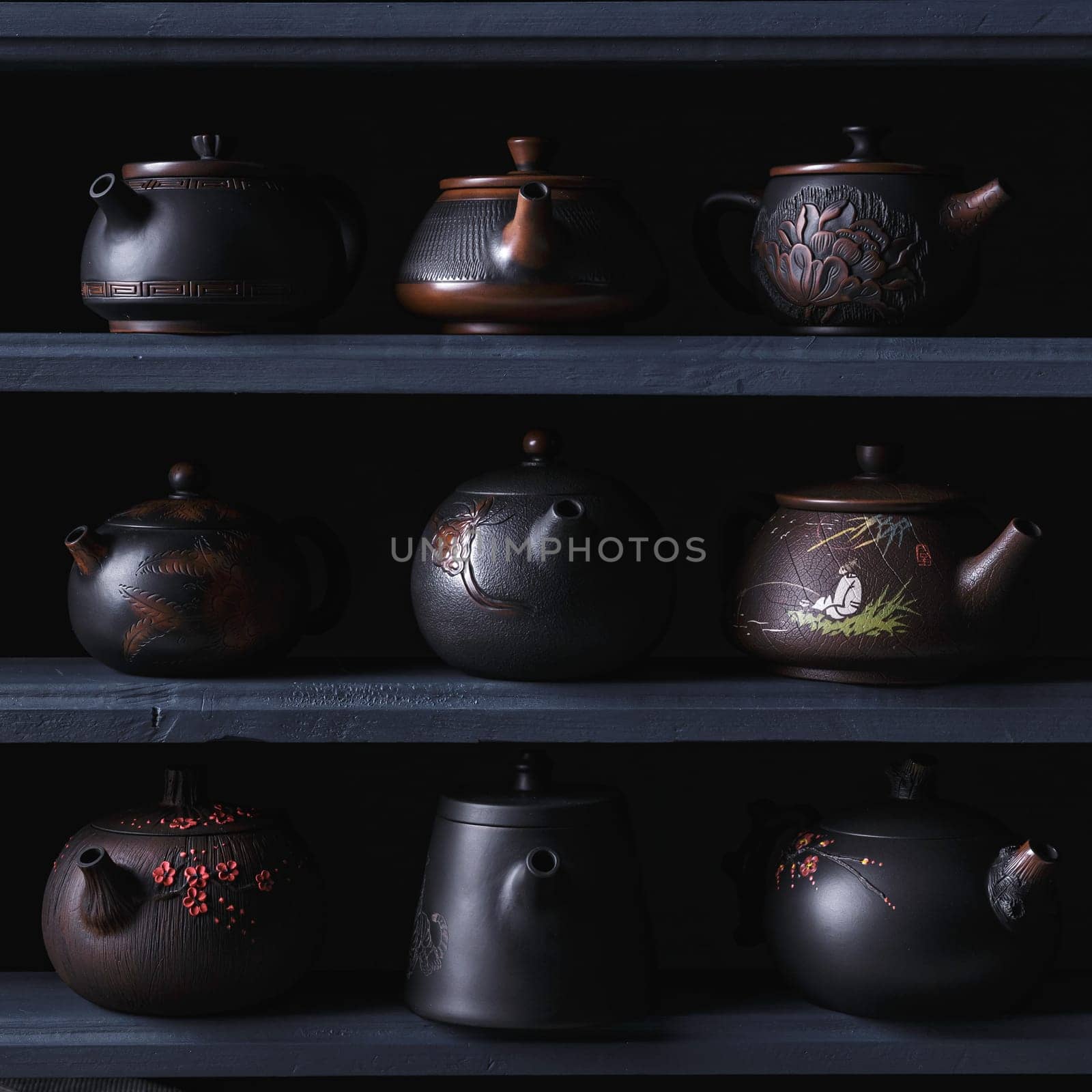 An elegantly curated display of black teapots that exemplify unique designs and exceptional fine craftsmanship