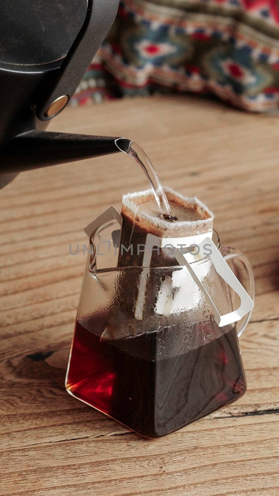 A detailed view showcasing the intricate process of coffee brewing using elegant glassware and rich, dark coffee