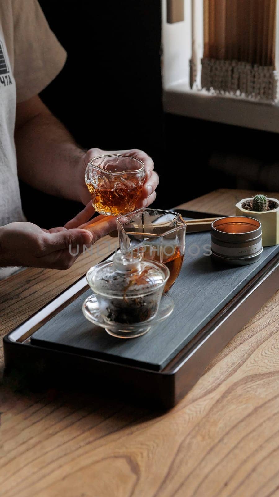 A tranquil and serene moment of brewing aromatic tea with beautiful, elegant glassware and soft natural light
