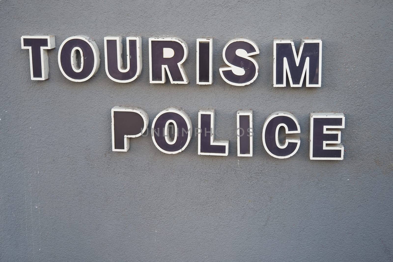 A signboard indicating tourism police services available for visitors to the area