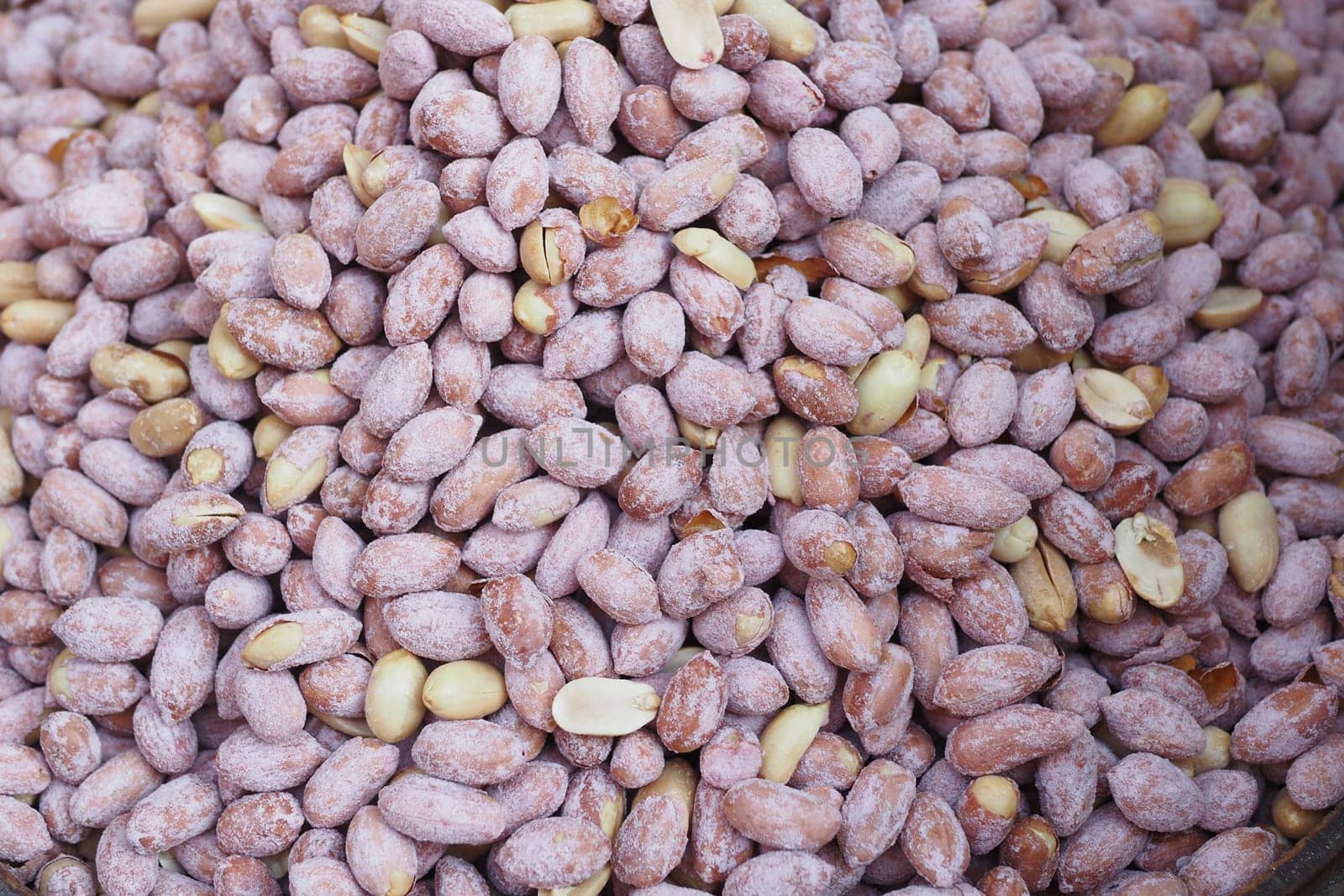 Close-Up Shot of Raw Peanuts With Textured Shells in Bulk.