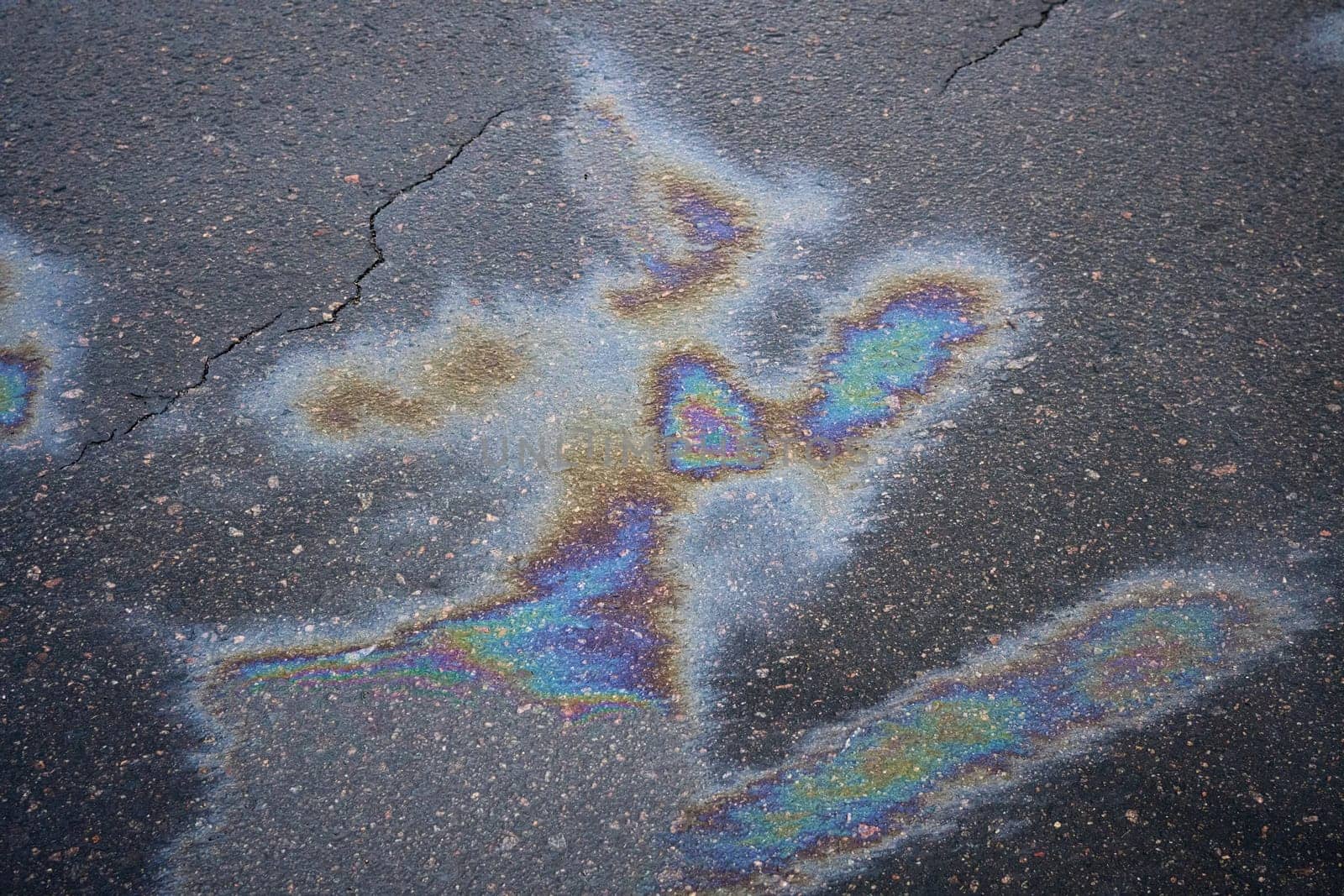 Striking oil spill displaying bright colors on the asphalt surface