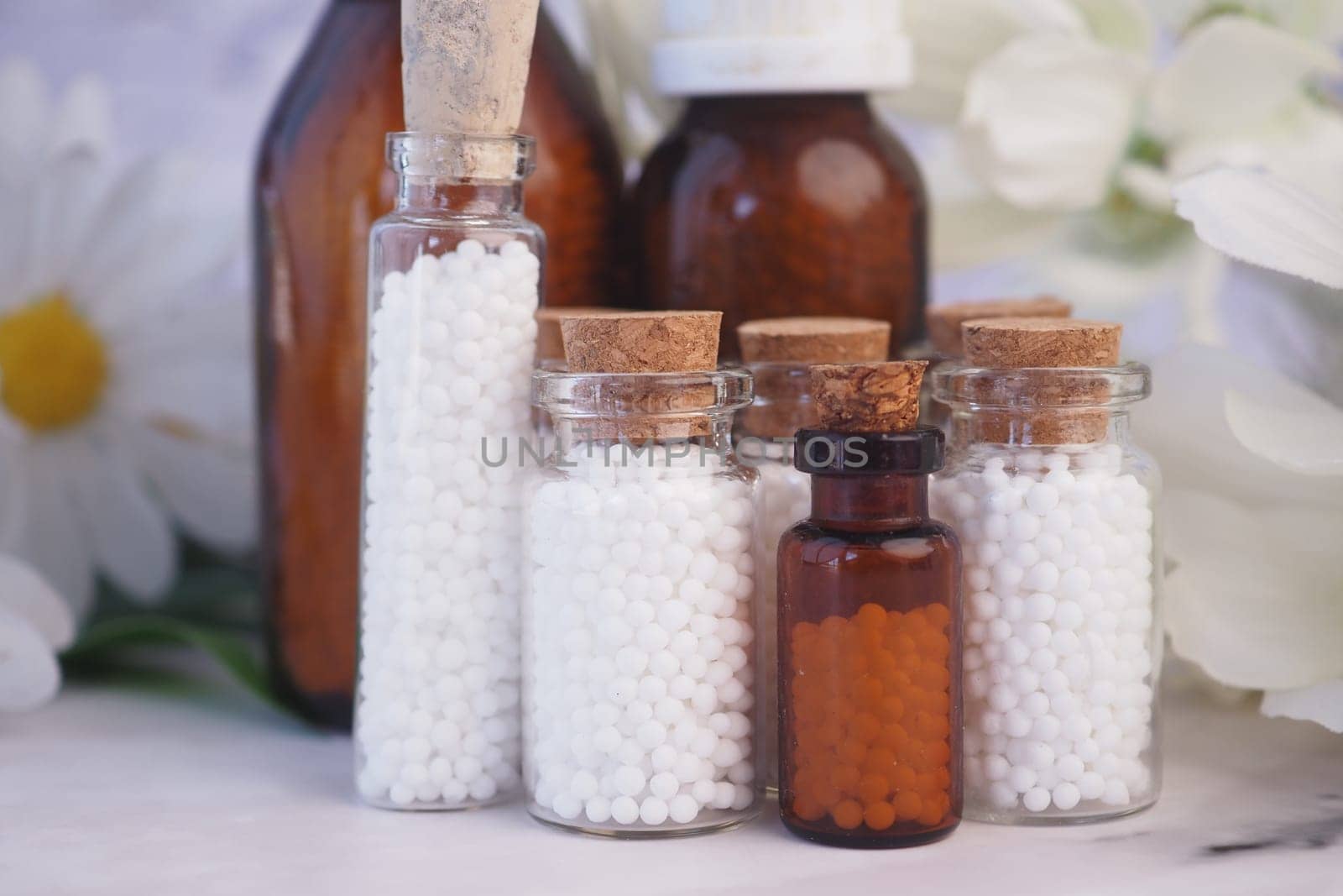 Homeopathic pills containers on a table .