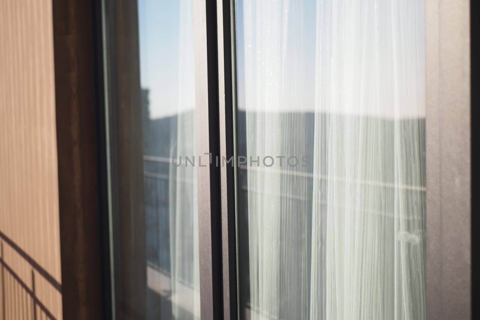 An elegantly designed sleek balcony view that showcases beautiful sheer curtains