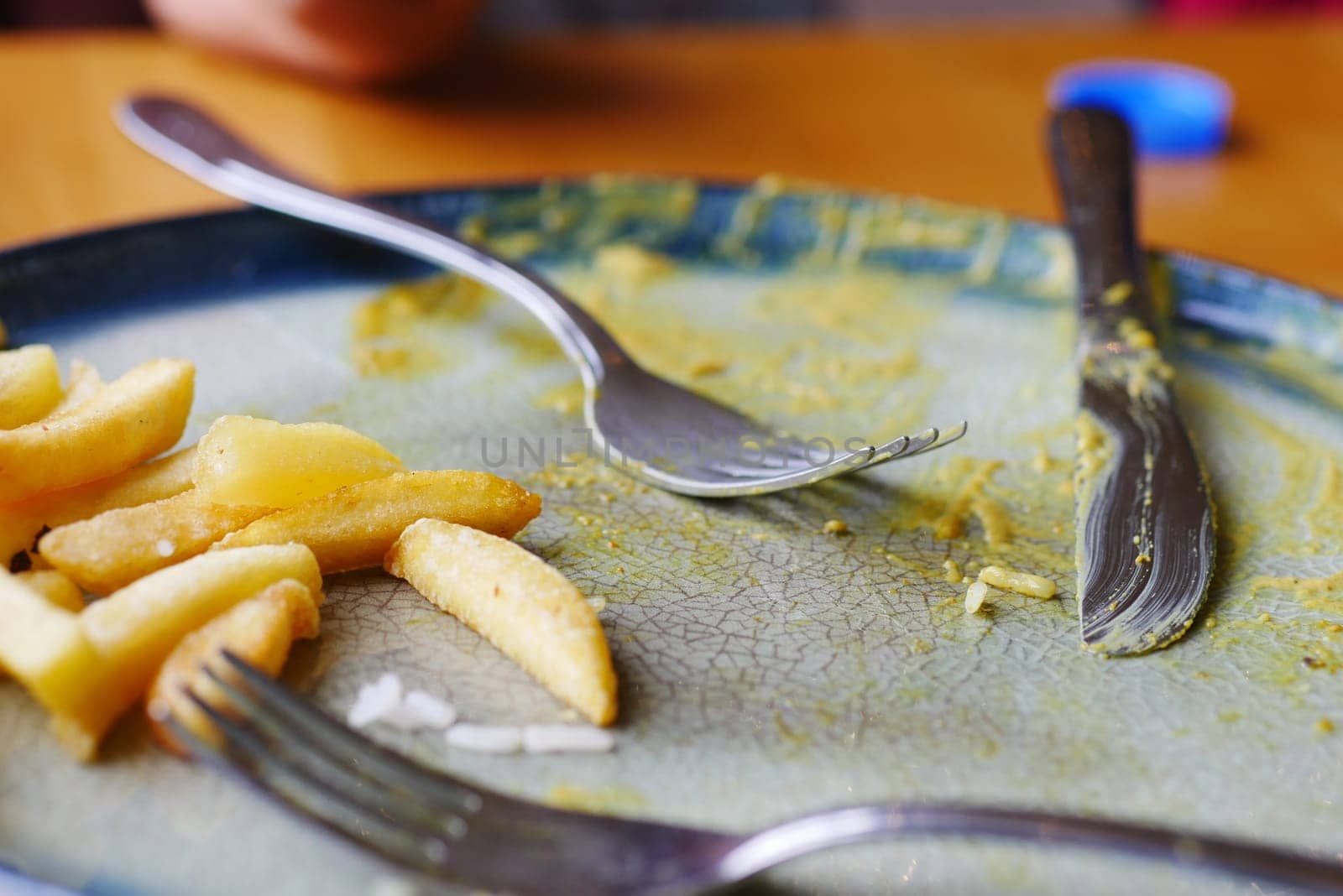 A used plate adorned with remnants, showcasing the delightful aftermath of a delicious meal