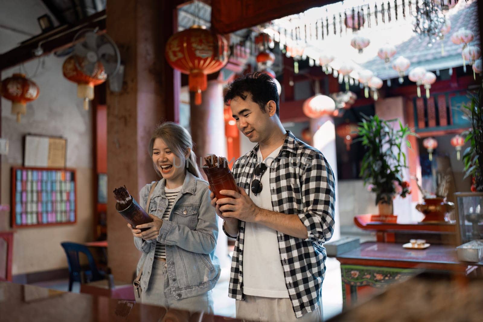 A joyful couple explores unique cultural artifacts in a vibrant marketplace the spirit of travel and discovery.