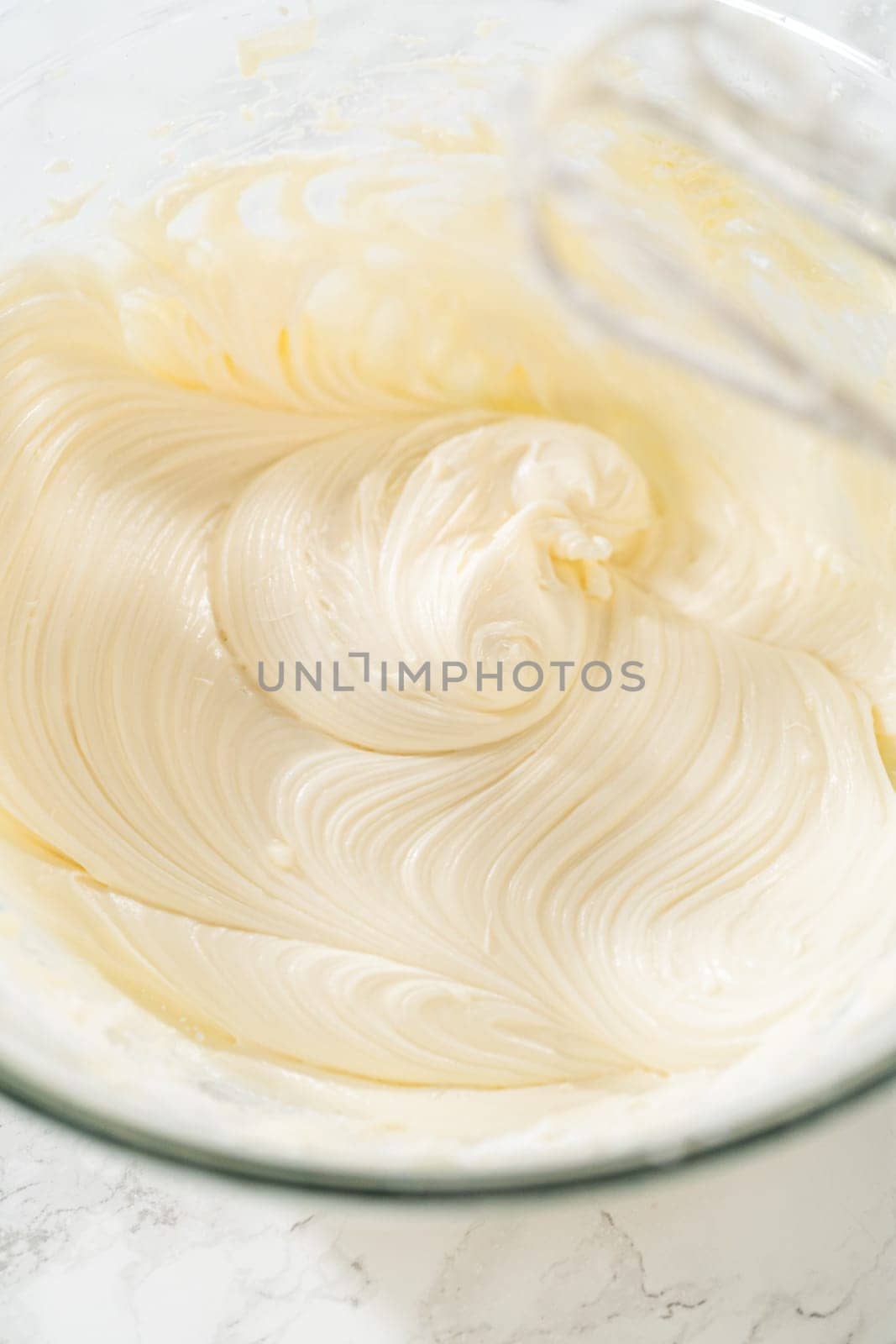 Preparing cream cheese frosting to ice the delicious pumpkin bundt cake.
