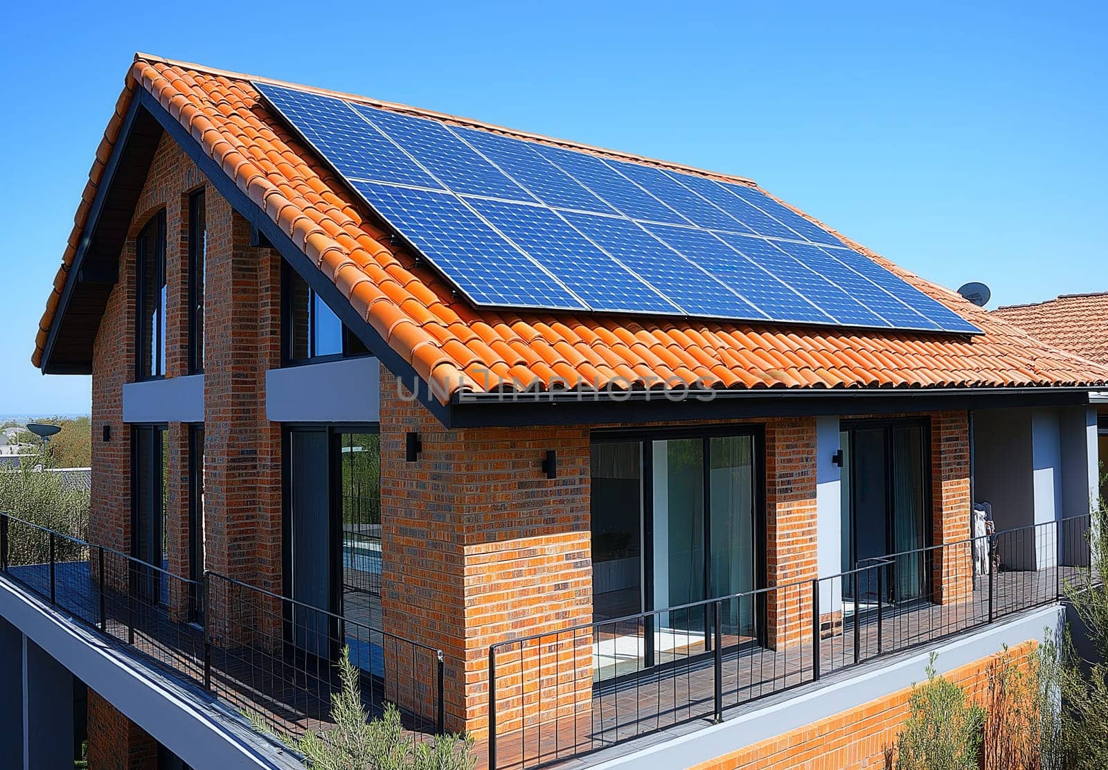 The roof of the residential building is equipped with solar panels. Selective focus.