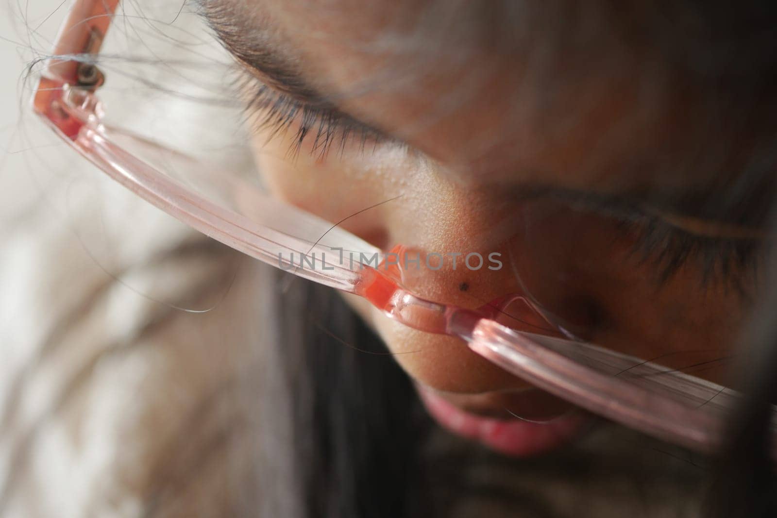 Closeup portrait of a little girl with glasses and long eyelashes