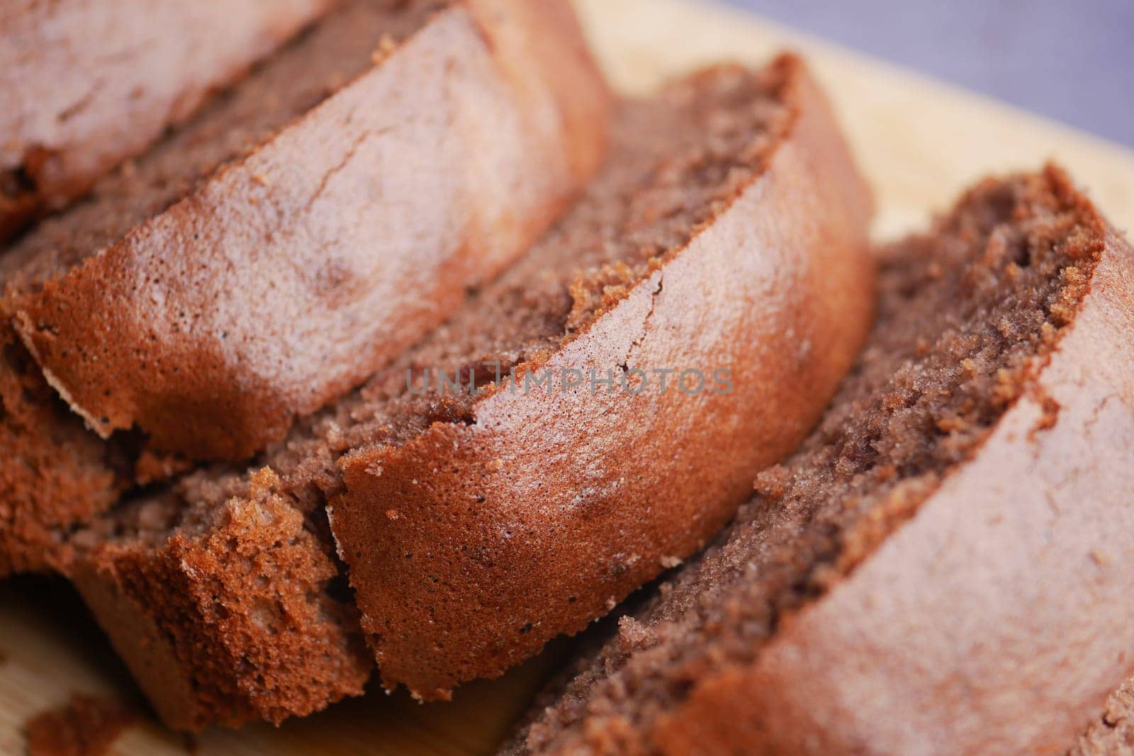 Enjoy this enticing view of a beautifully sliced chocolate loaf cake ready for savoring