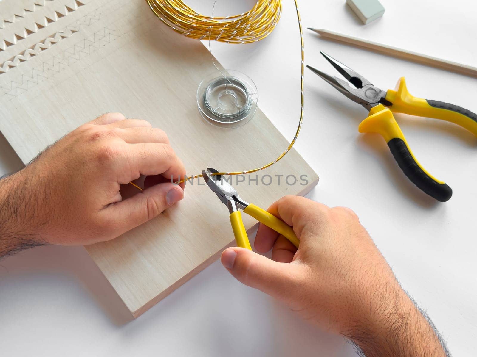 Crafting with precision. Hand tools and wire for diy projects.