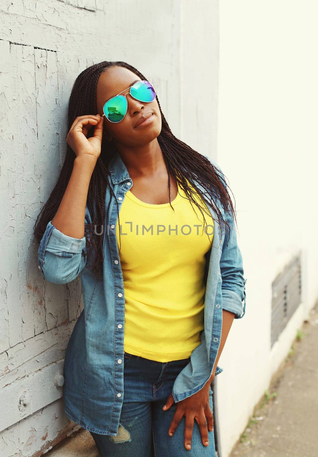 Fashion beautiful african woman in colorful clothes and sunglasses