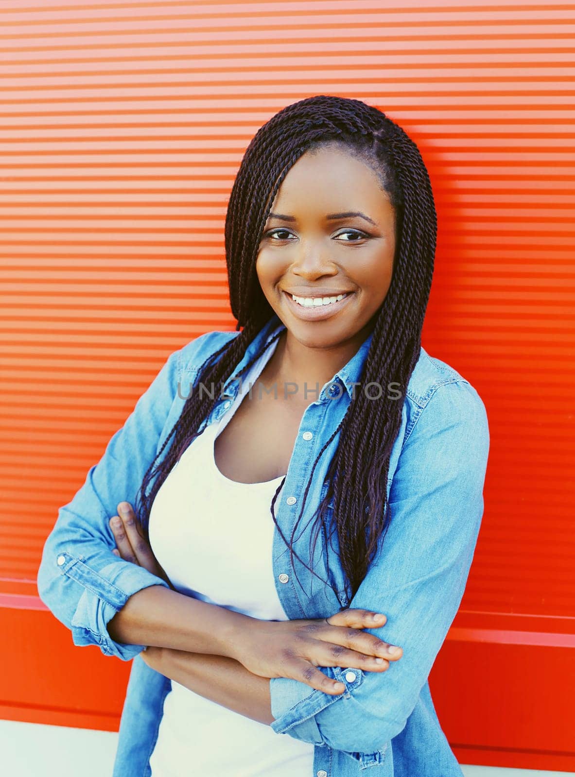 Portrait beautiful smiling african woman over red background