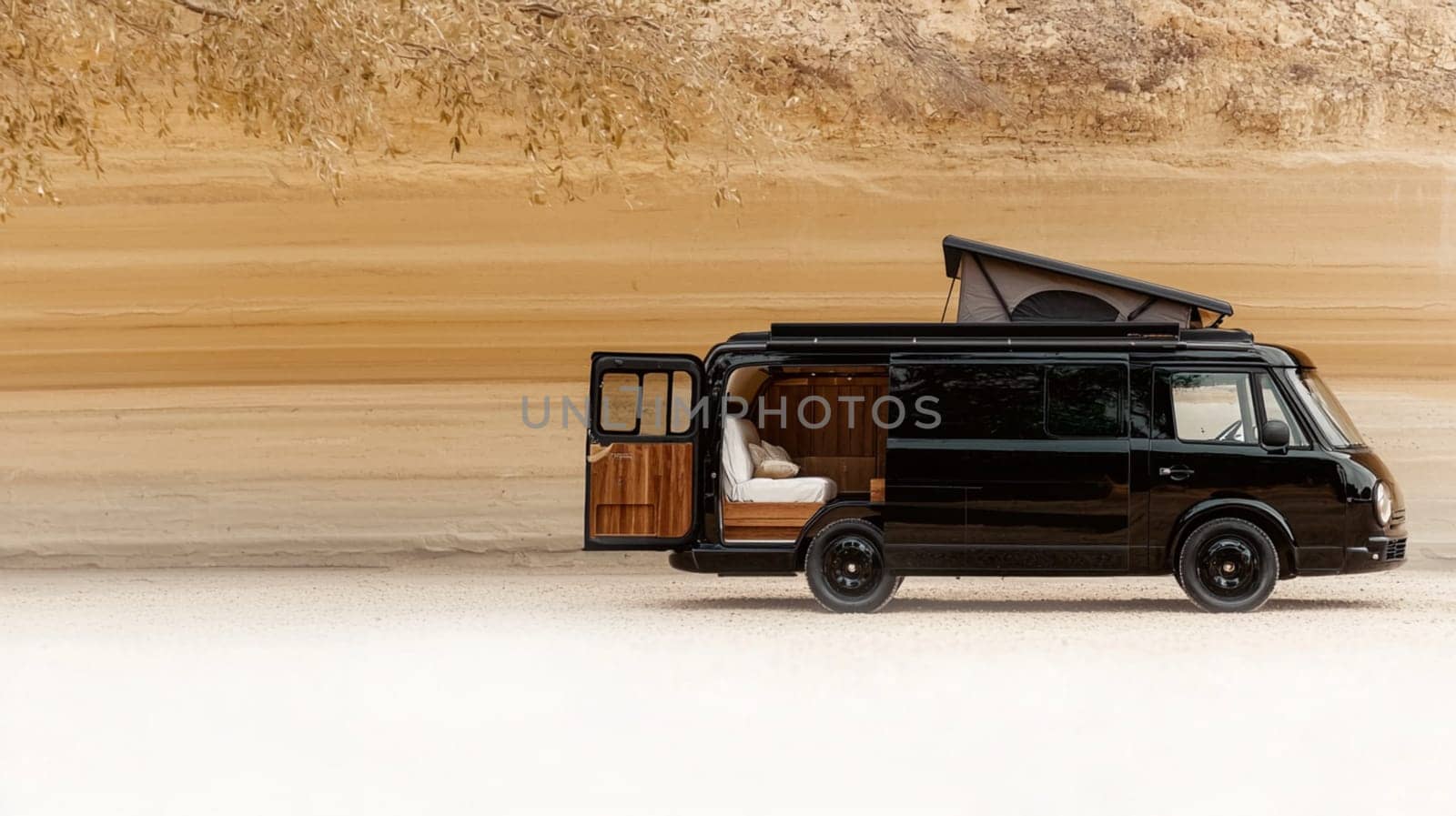 Sleek black camper van is parked in a field, its door open to reveal a cozy interior, inviting you to experience the freedom of the open road