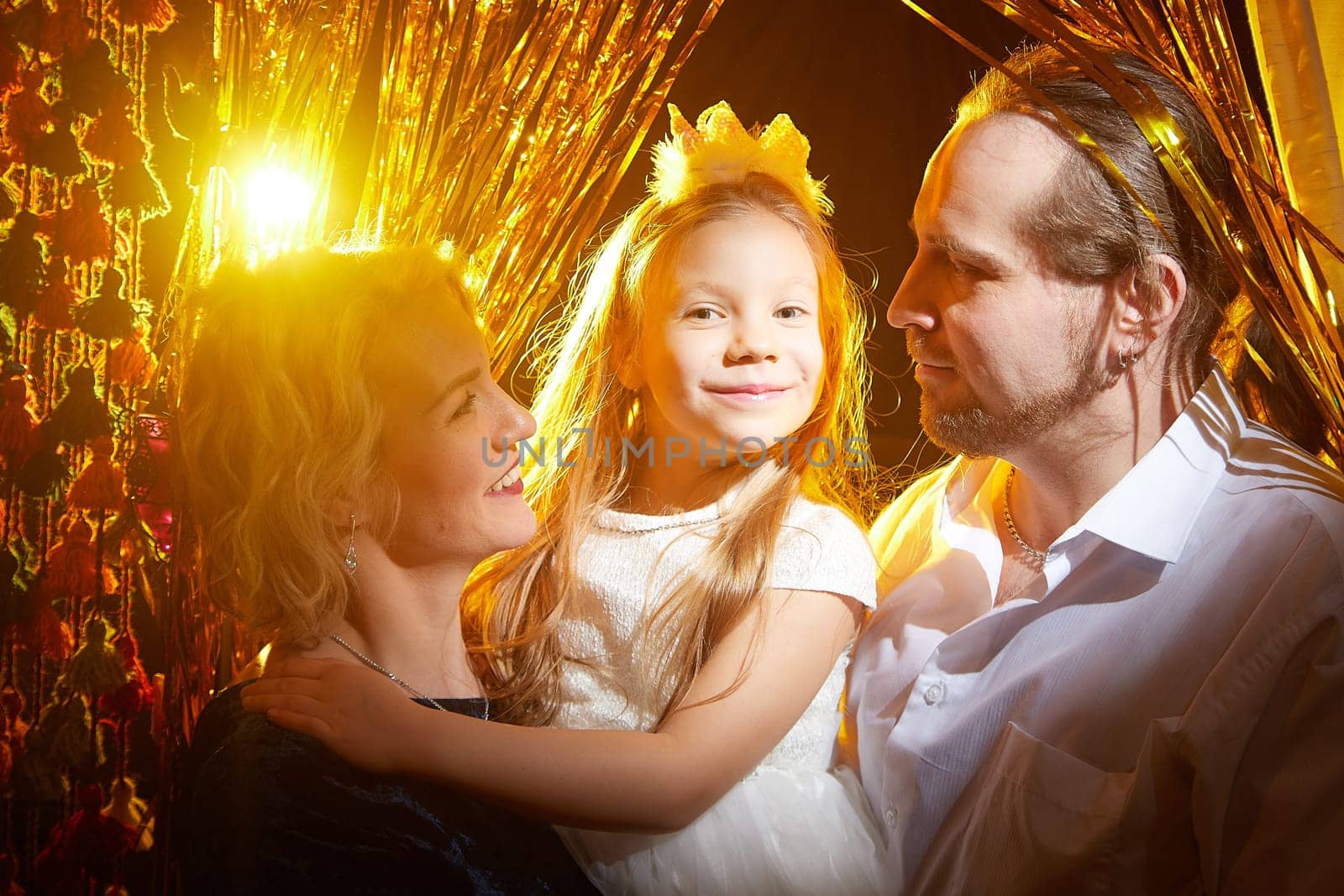 Family enjoys a joyful moment together, surrounded by festive decorations, celebrating the holiday spirit.