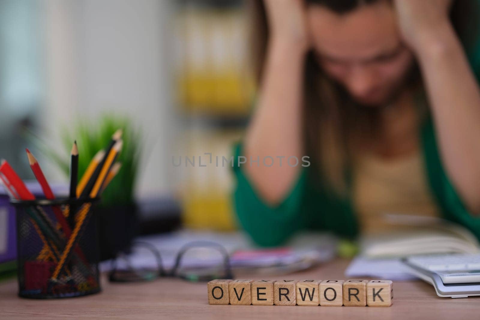 An informative image illustrating the harmful effects of overwork and stress in a professional setting