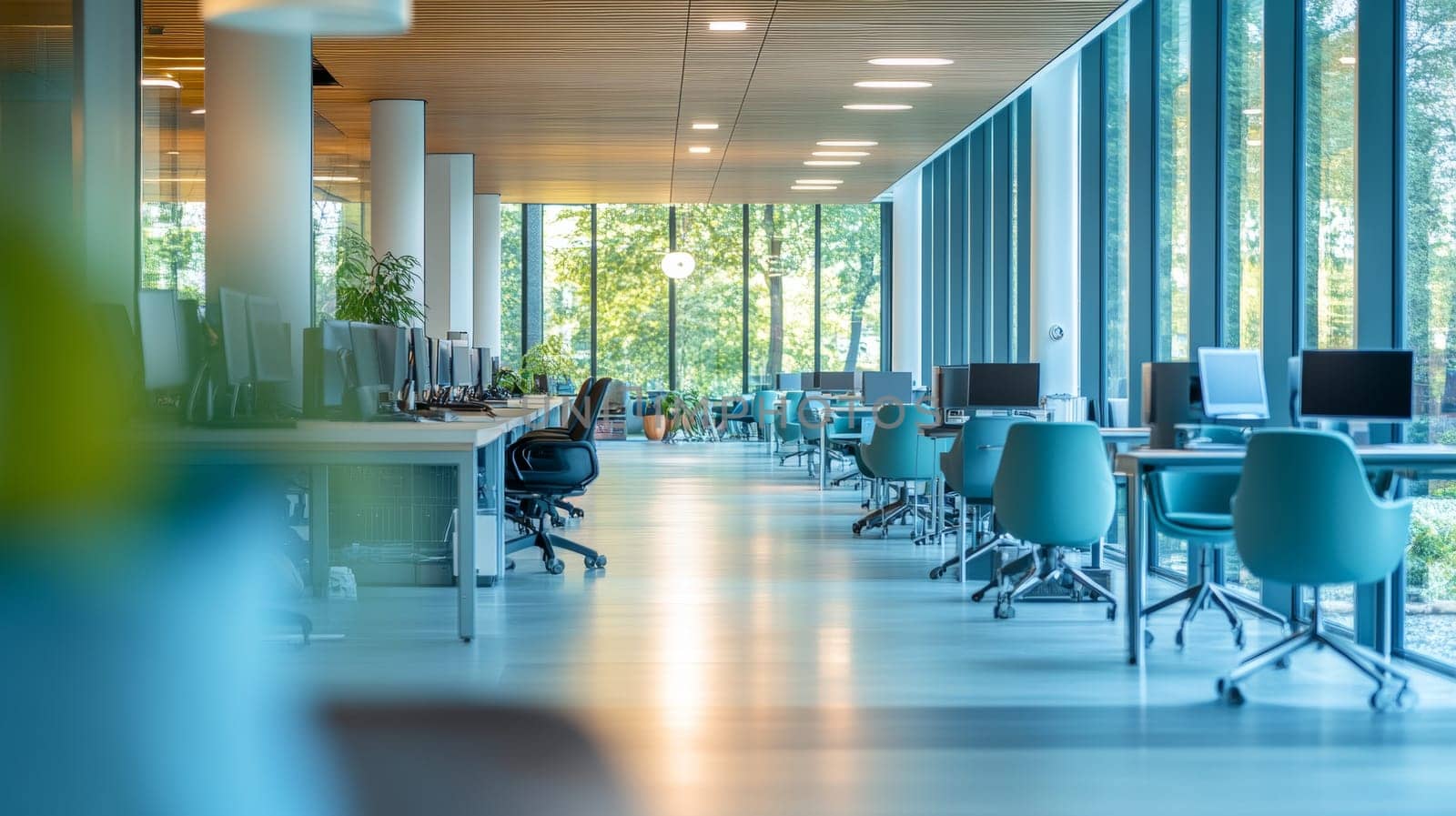 Modern, spacious office interior with a row of computer desks. Bright and airy workspace.