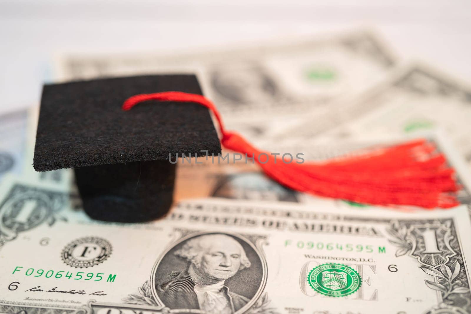 Graduation gap hat on Euro and US dollar banknotes money, Education study fee learning teach concept. by pamai