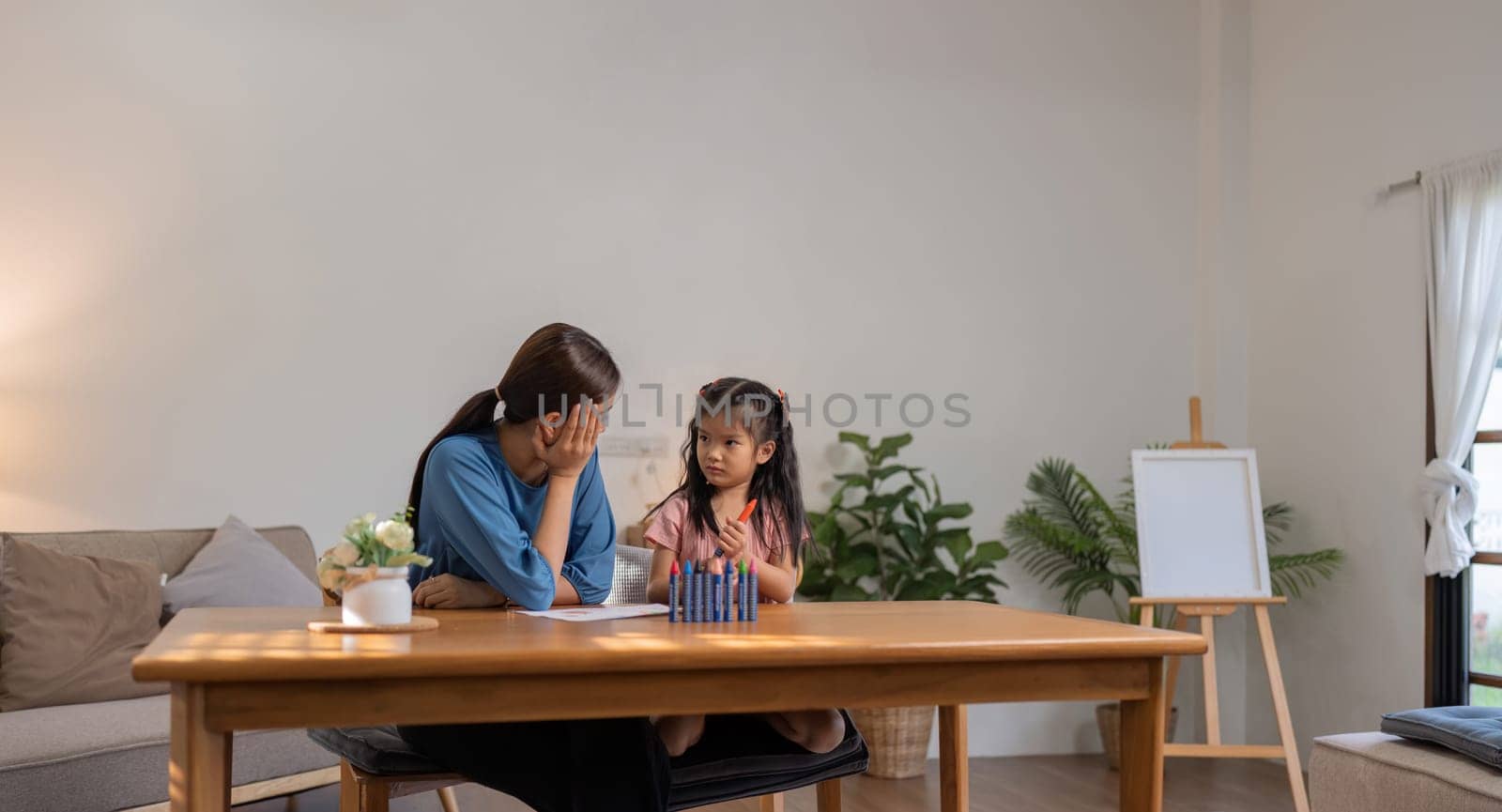 Mother and her daughter draw in the paper together, Leisure activities, holiday.