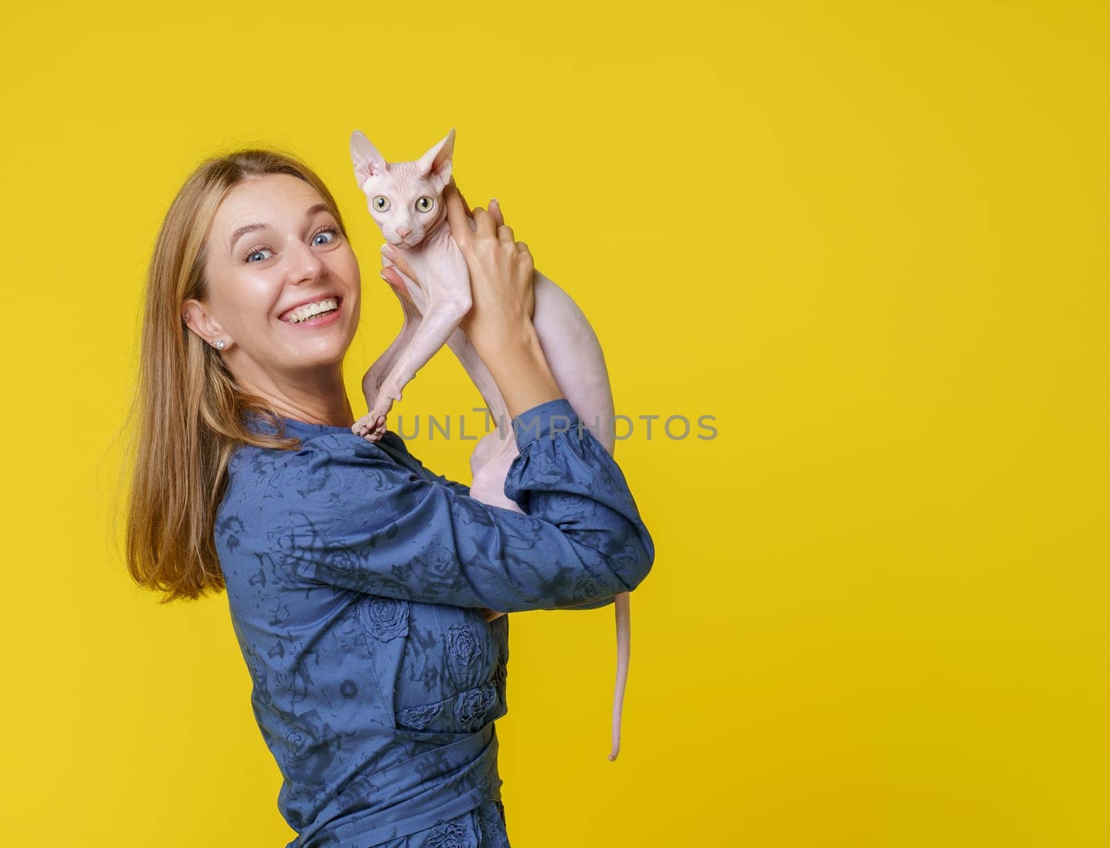 Woman shares heartwarming moment with beloved cat and kisses it affectionately and holds it in hands. Deep bond and love between pet owner and feline companion, reflecting joyful and cherished connection. High quality photo
