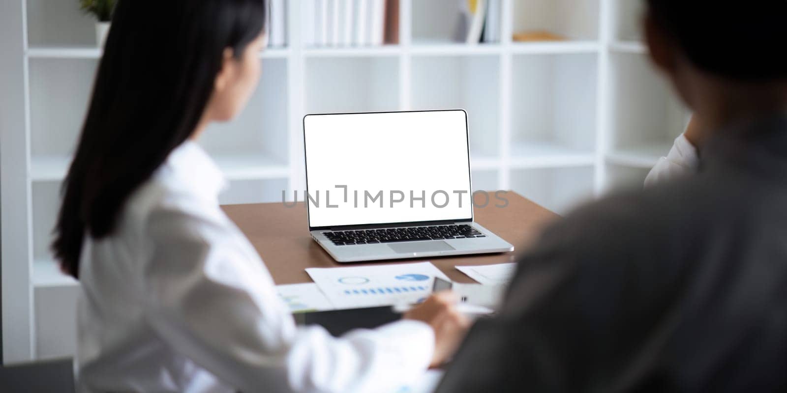 blank screen of man hand working on laptop computer and work while sitting at the table, mockup blank screen for product display or graphic design.
