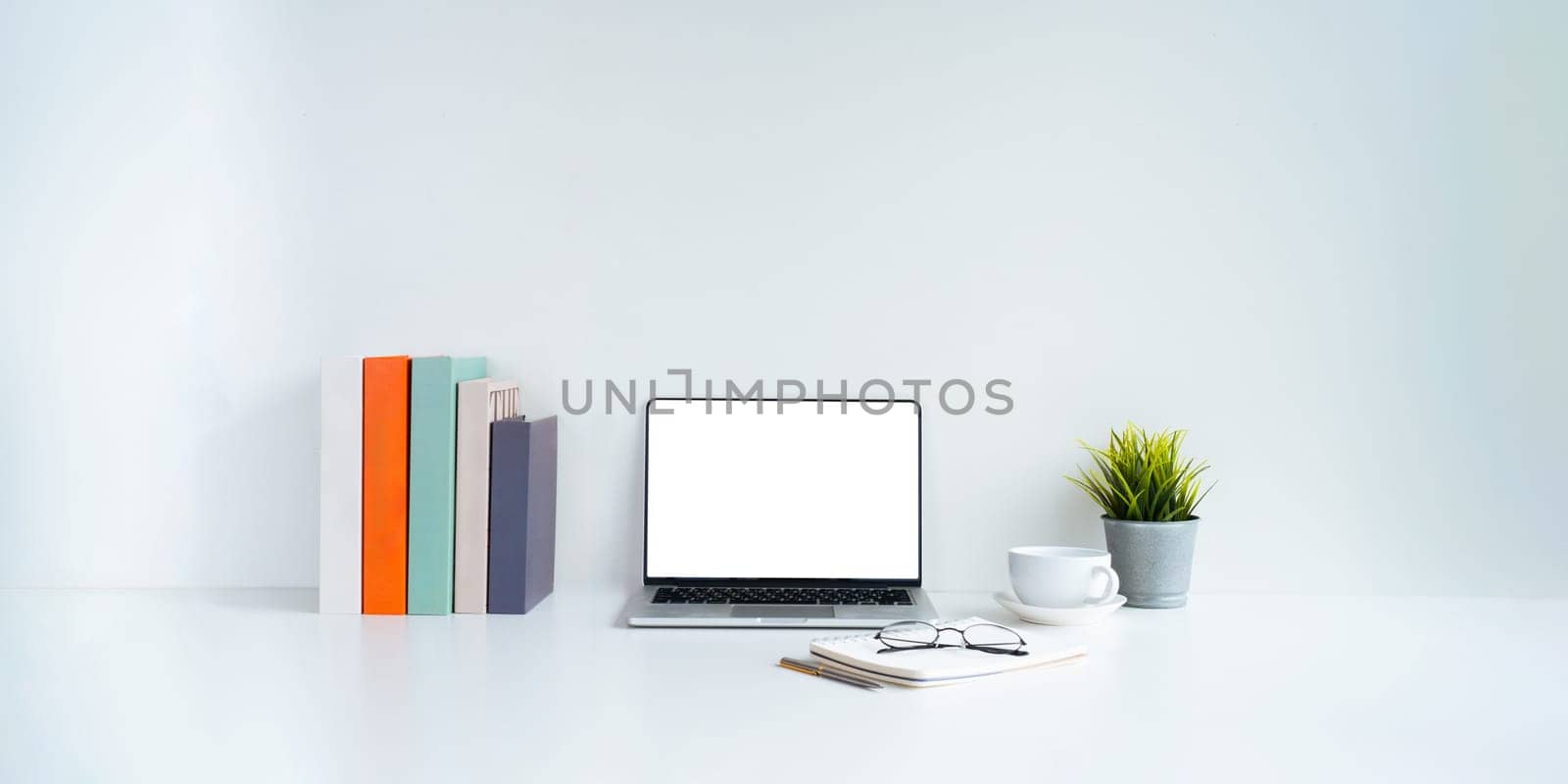 Laptop computer mockup blank white screen on table in white background. laptop with blank screen on table of workplace contemporary white background by nateemee