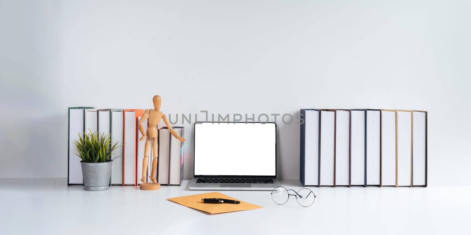 Laptop computer mockup blank white screen on table in white background. laptop with blank screen on table of workplace contemporary white background.