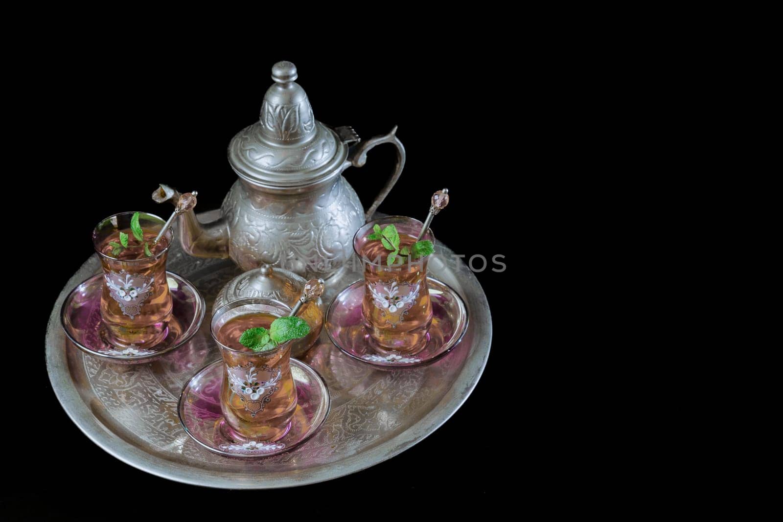 tray with Moorish tea with mint and silver pitcher and sugar bowl by joseantona