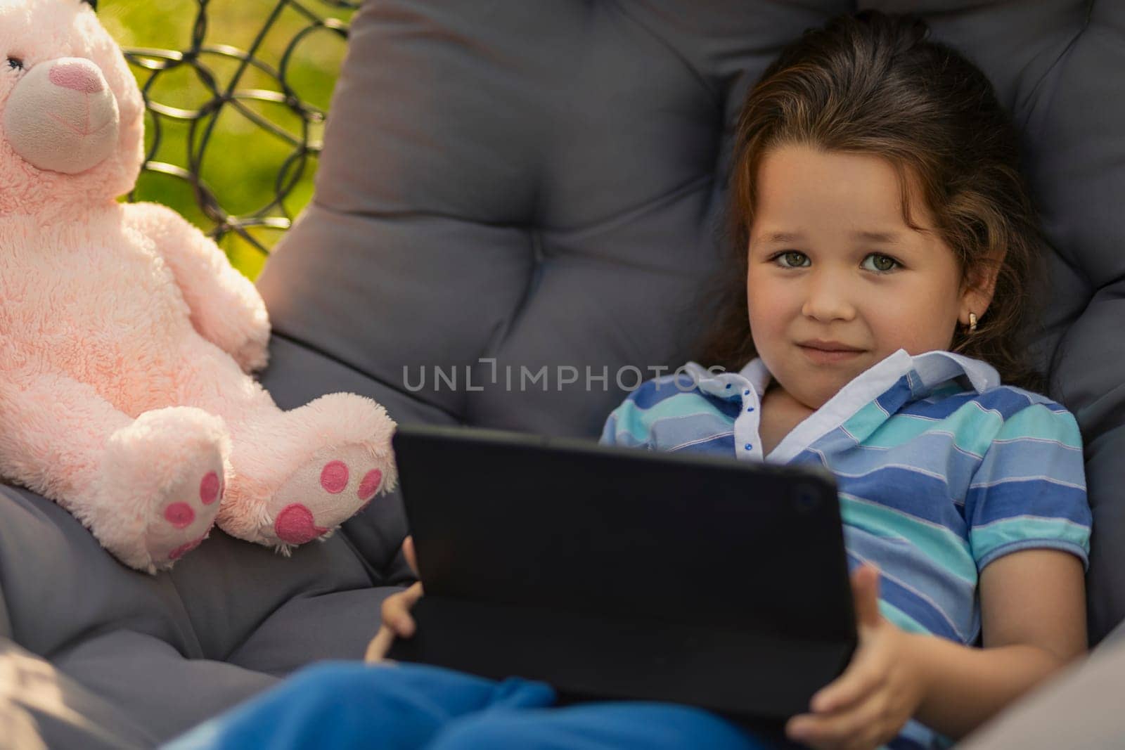 little girl looking at tablet, modern outdoor recreation