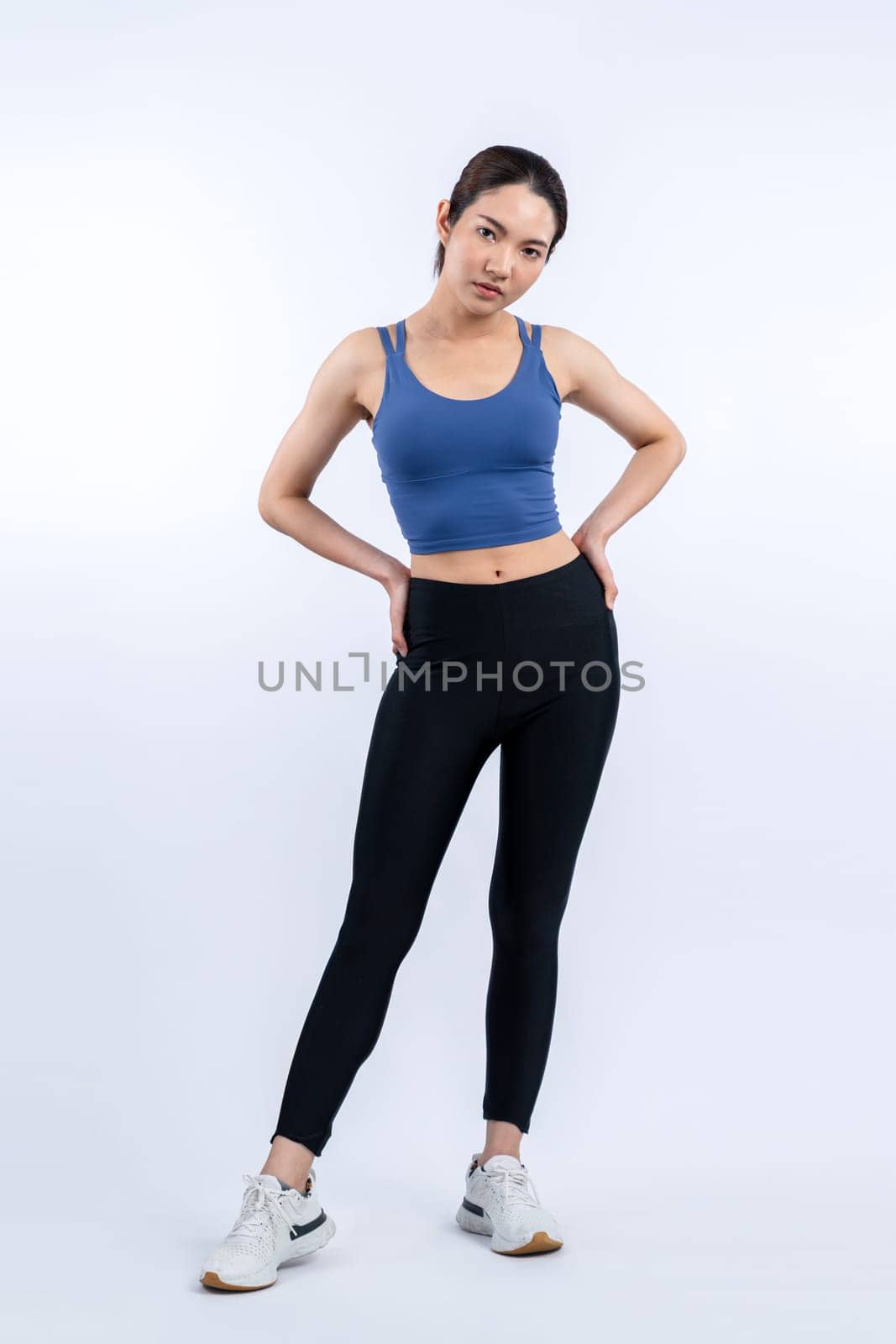 Full body asian woman in sportswear portrait, smiling and posing cheerful gesture. Workout training with attractive girl engage in her pursuit of healthy lifestyle. Isolated background Vigorous