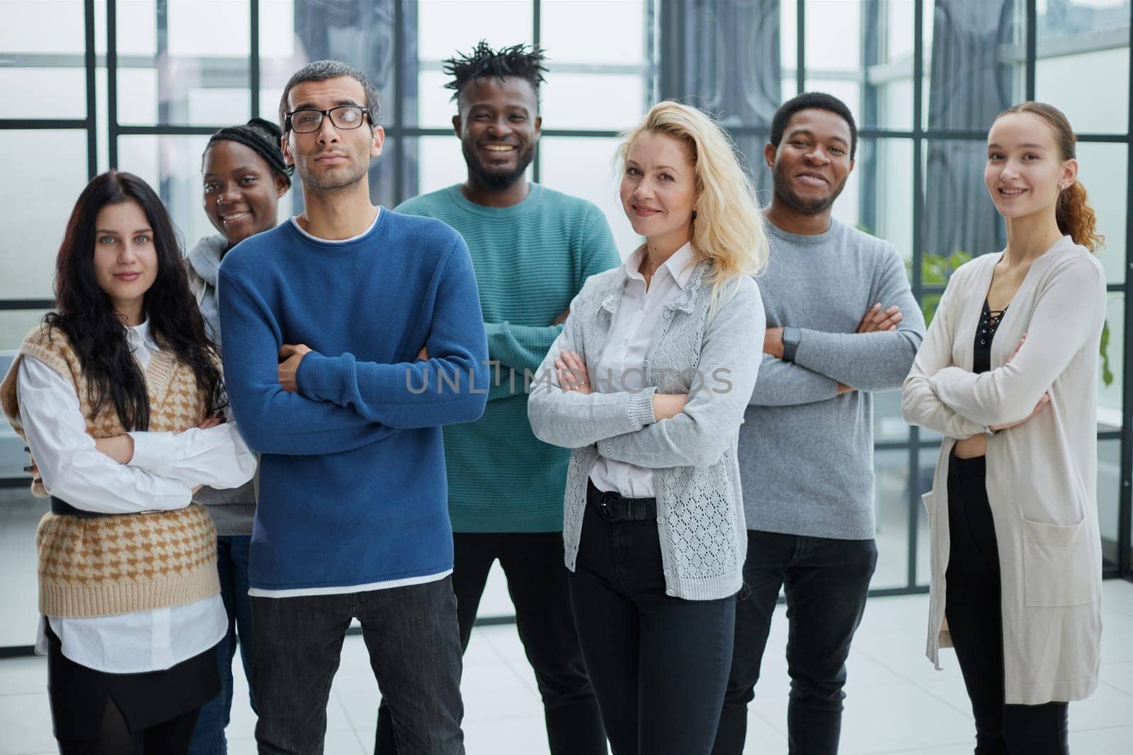 Group of business people standing at the window of a modern office by Prosto